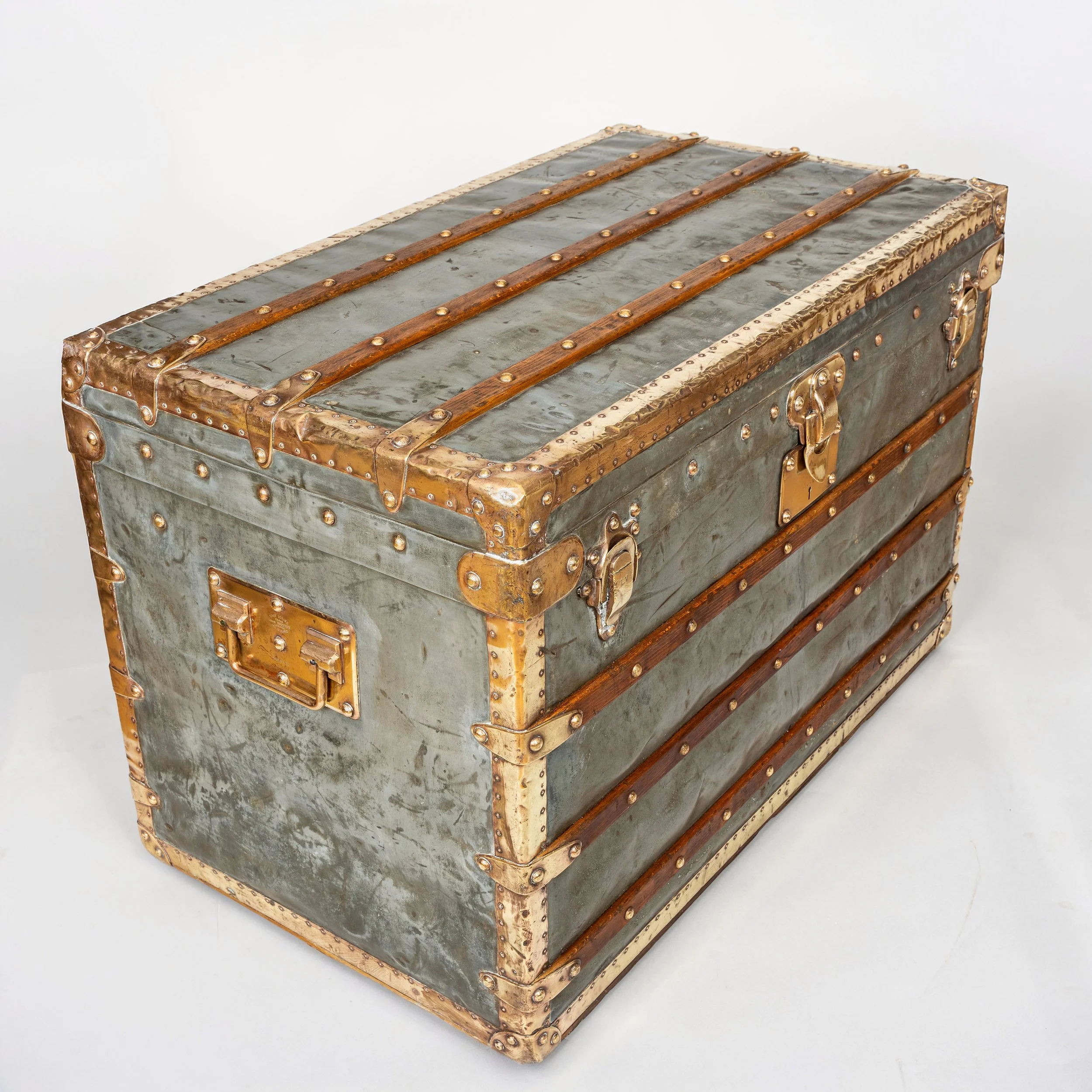 Louis Vuitton zinc steamer trunk, circa 1895, brass bound, seen from the front corner — Daniels Antiques