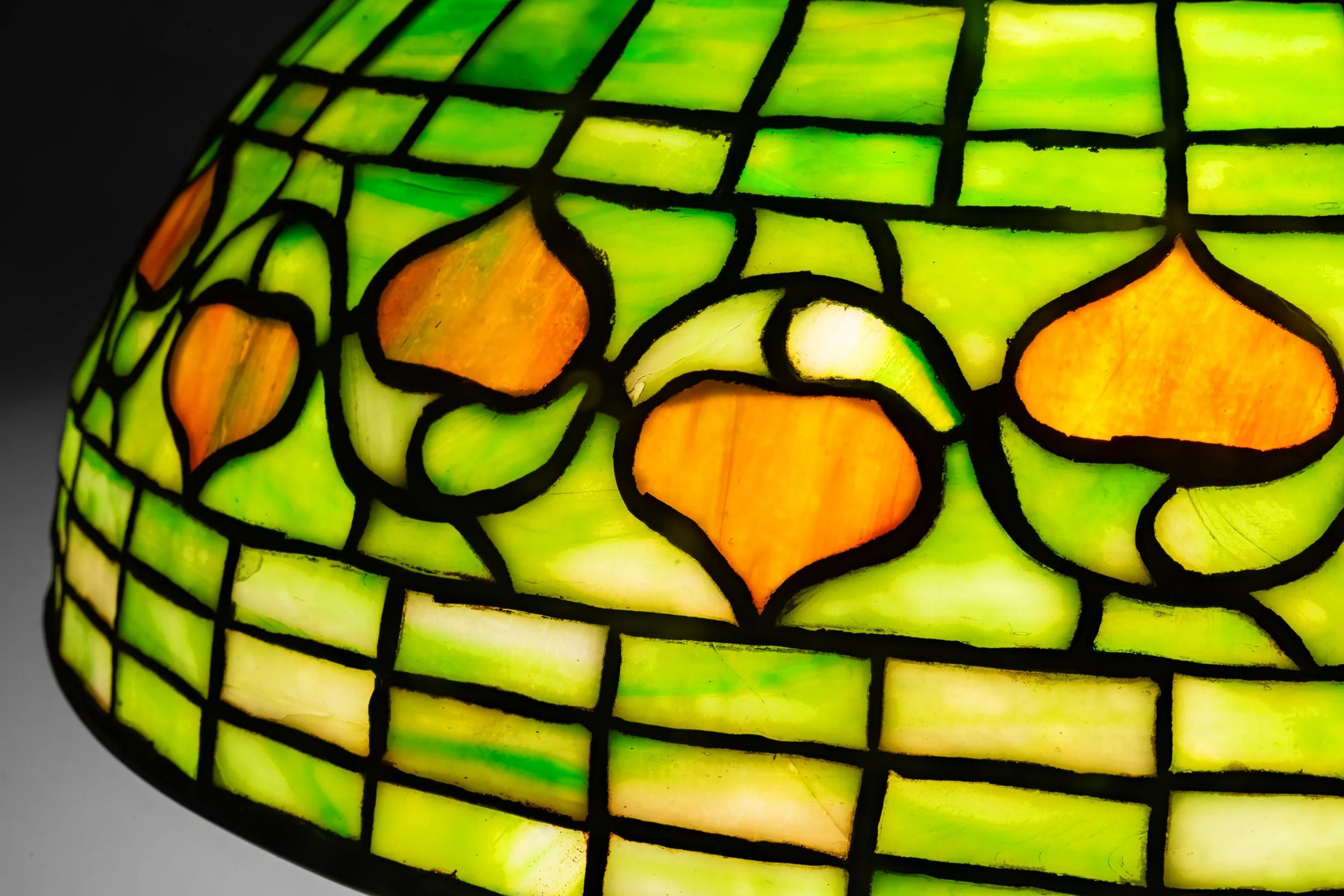 Tiffany Studios Vine Border lamp leaded glass detail, amber leaf border on green ground — Daniels Antiques