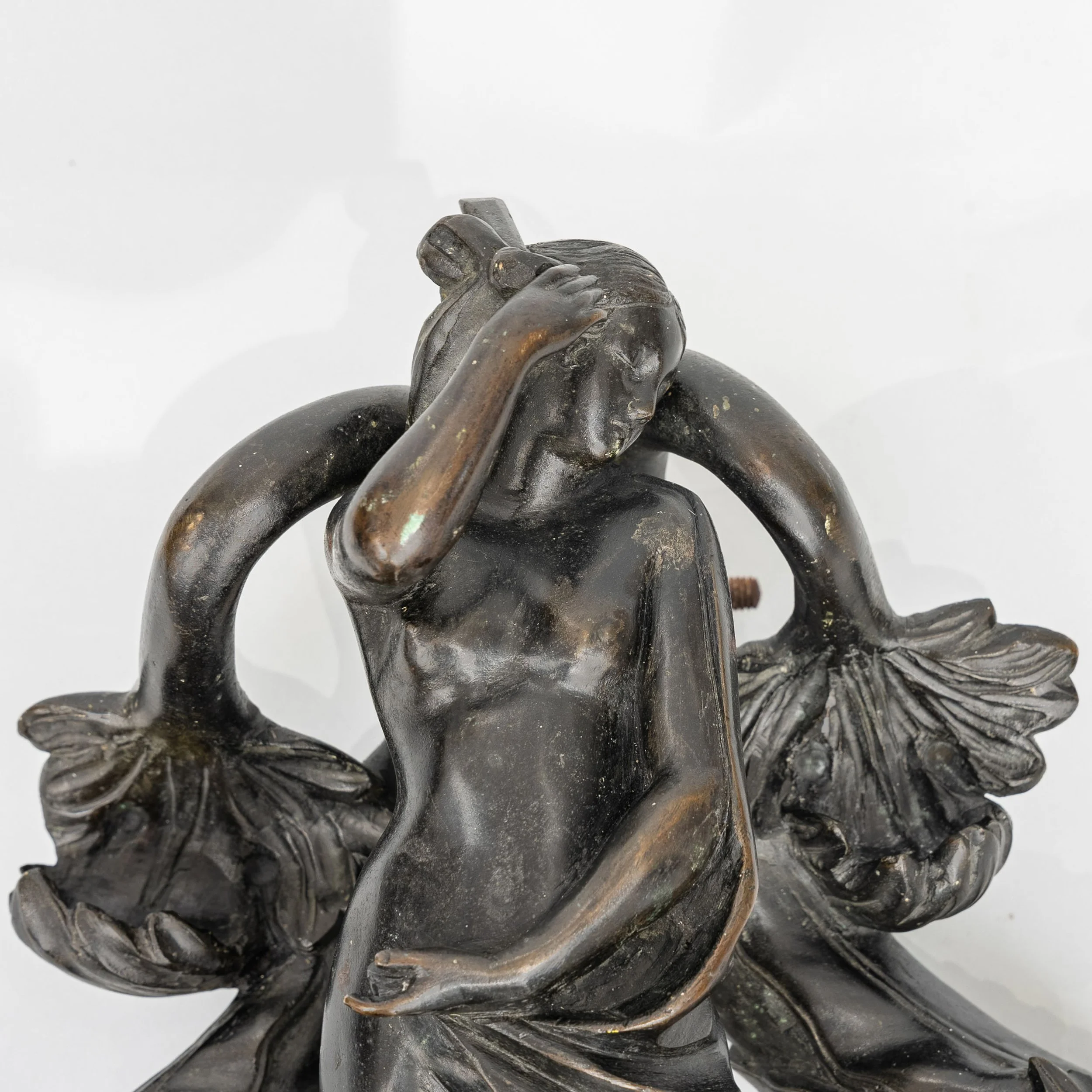 Detail of the Venus figure on an Italian bronze door knocker, hand raised to her hair — Daniels Antiques