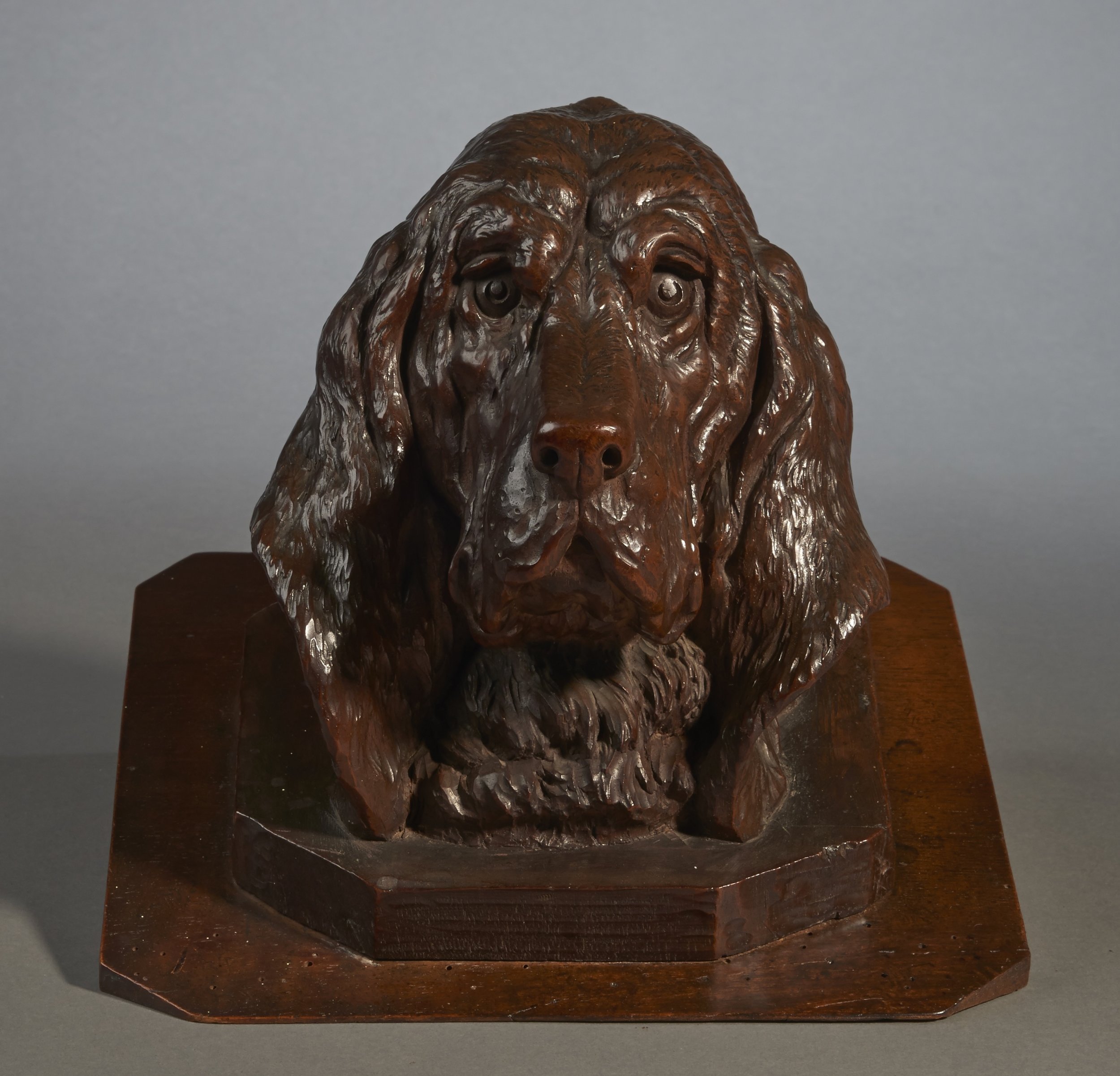 Black Forest carved walnut bird dog head on octagonal stepped base, c. 1870, with classically carved eyes