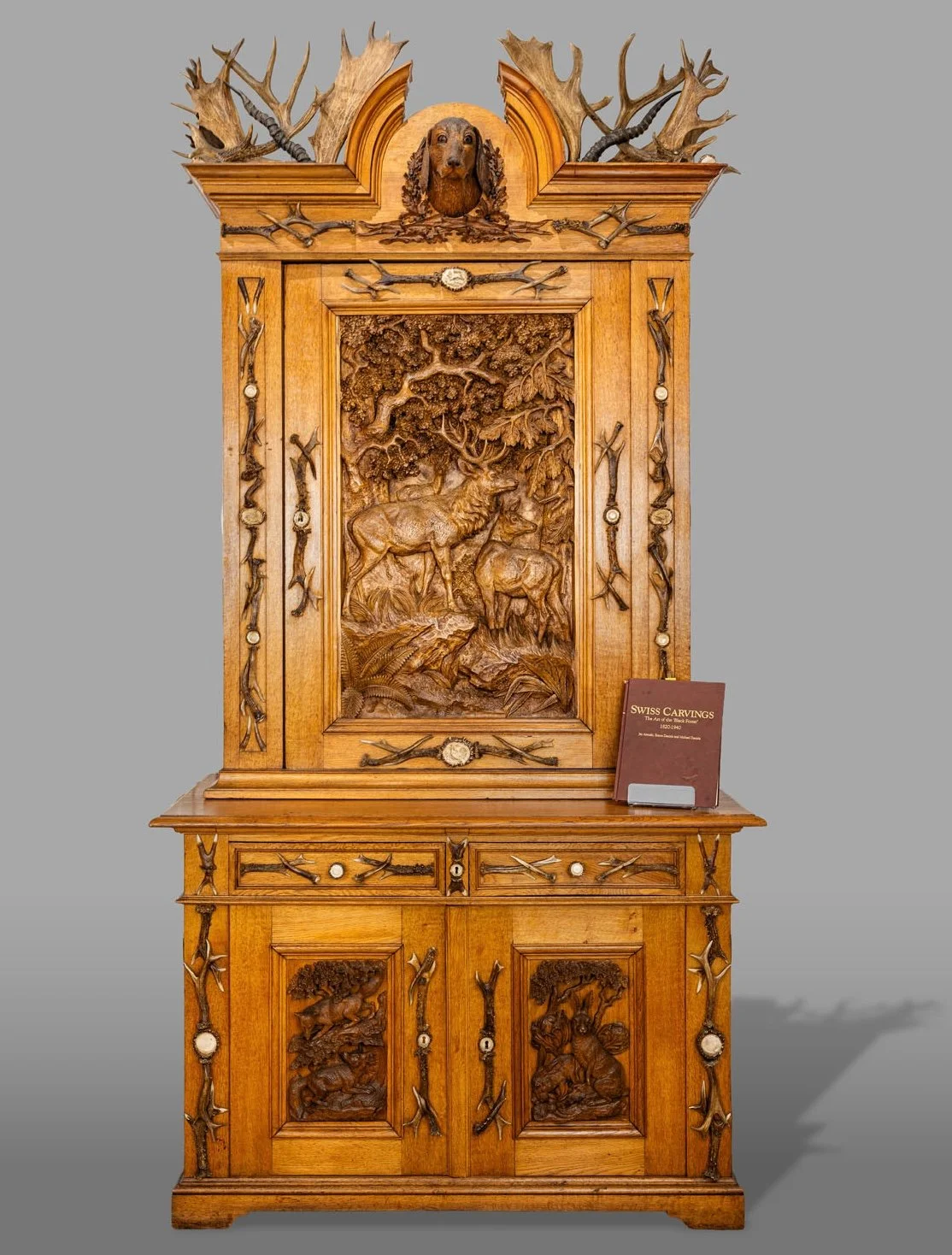 Black Forest Antler-Mounted Hunting Cabinet (Jagdschrank), Oak with Carved High-Relief Panels and Stag Horn Mounts, Late 19th Century
