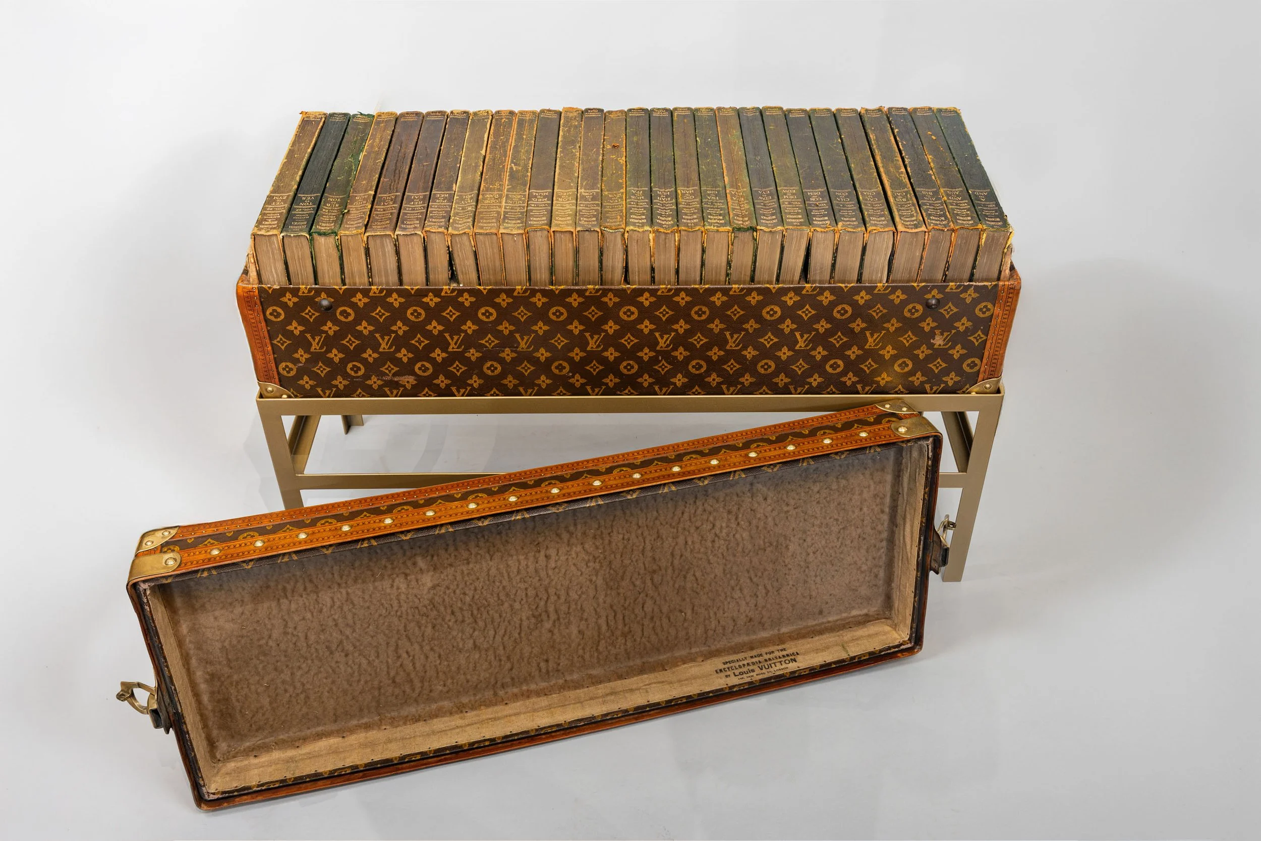 Open Louis Vuitton library trunk showing fitted interior lining