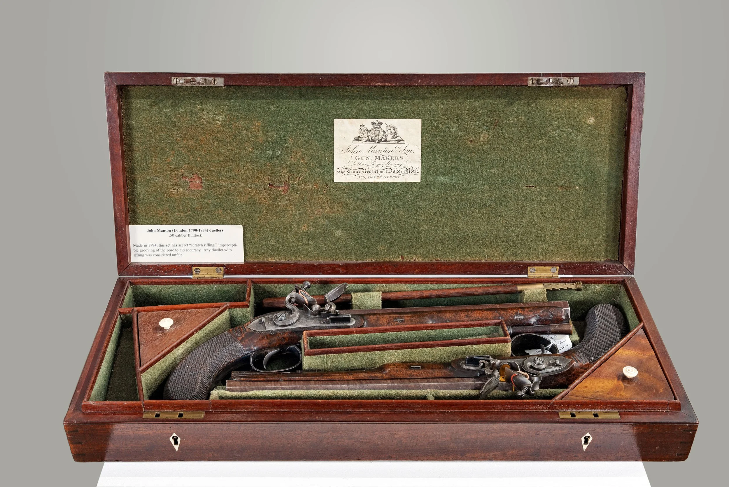 Cased pair of John Manton flintlock duelling pistols in mahogany case with trade label — Daniels Antiques