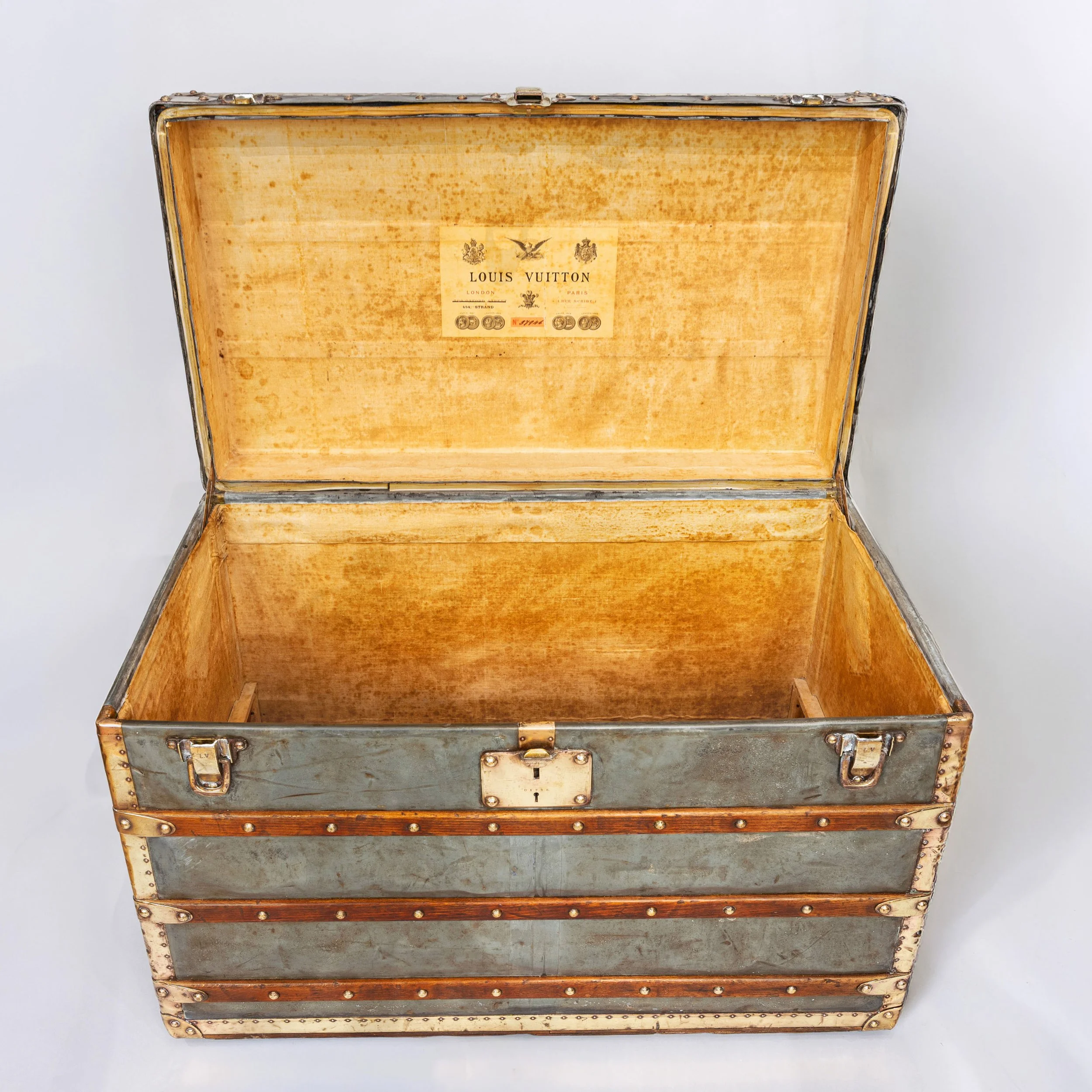 Open Louis Vuitton zinc trunk, circa 1895, showing the canvas lining and lid label — Daniels Antiques