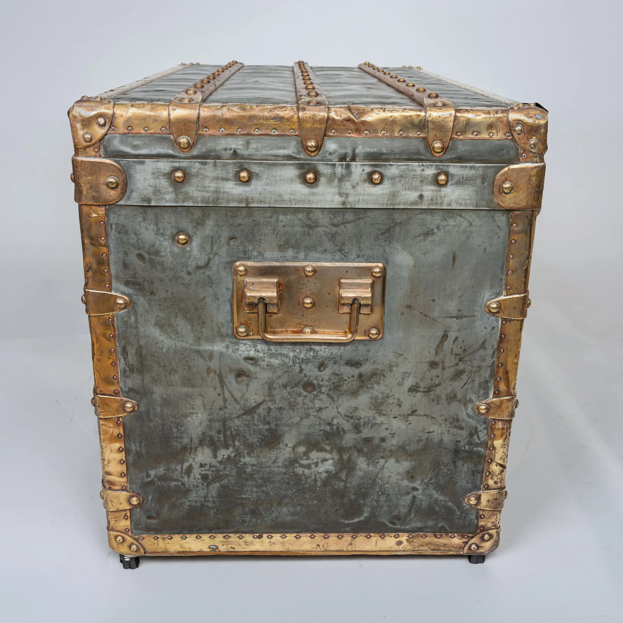 End of a Louis Vuitton zinc trunk, circa 1895, with stamped brass handle plate — Daniels Antiques