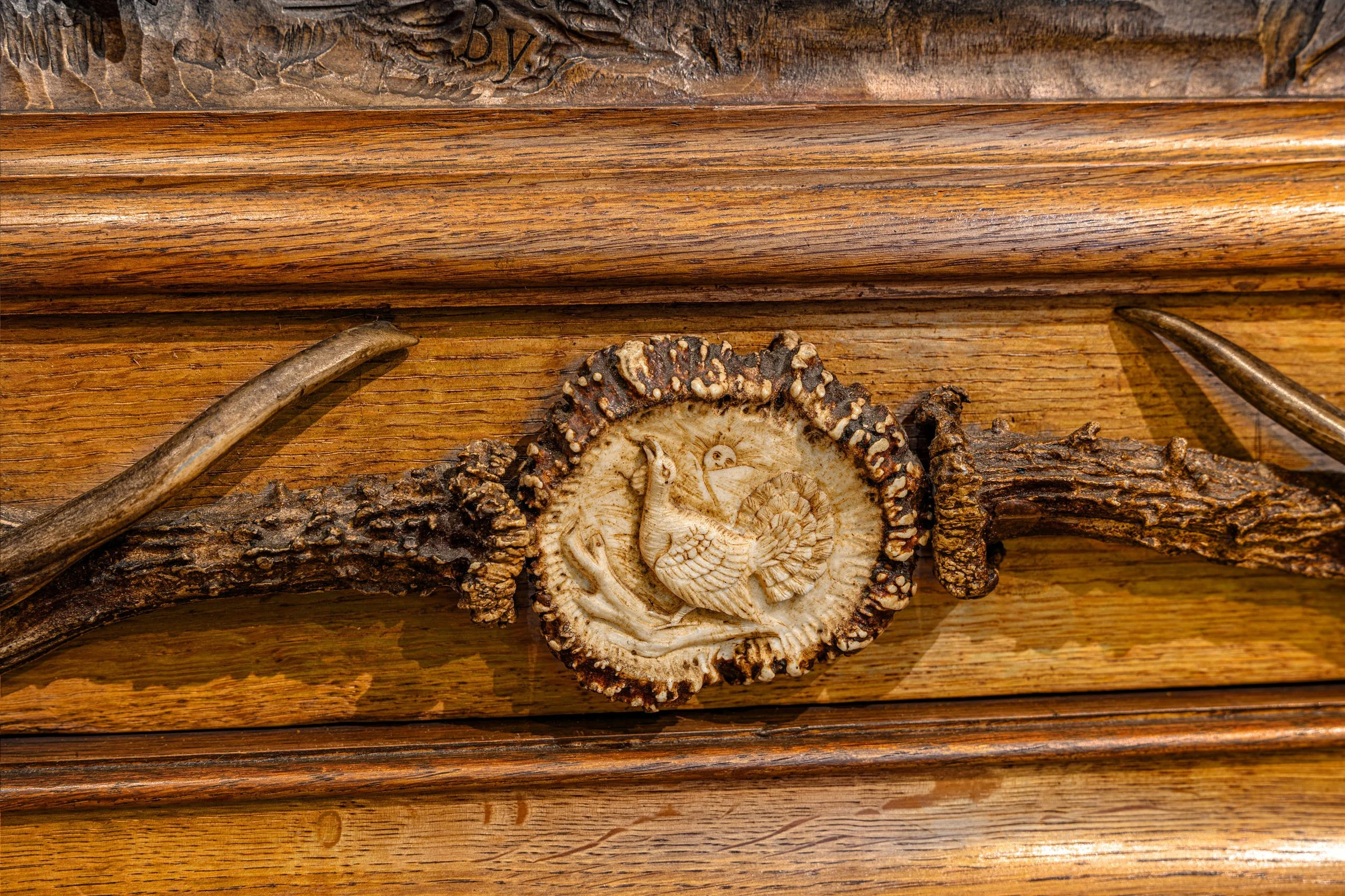 Antler mount with carved bone medallion depicting capercaillie, Black Forest hunting cabinet, late 19th century