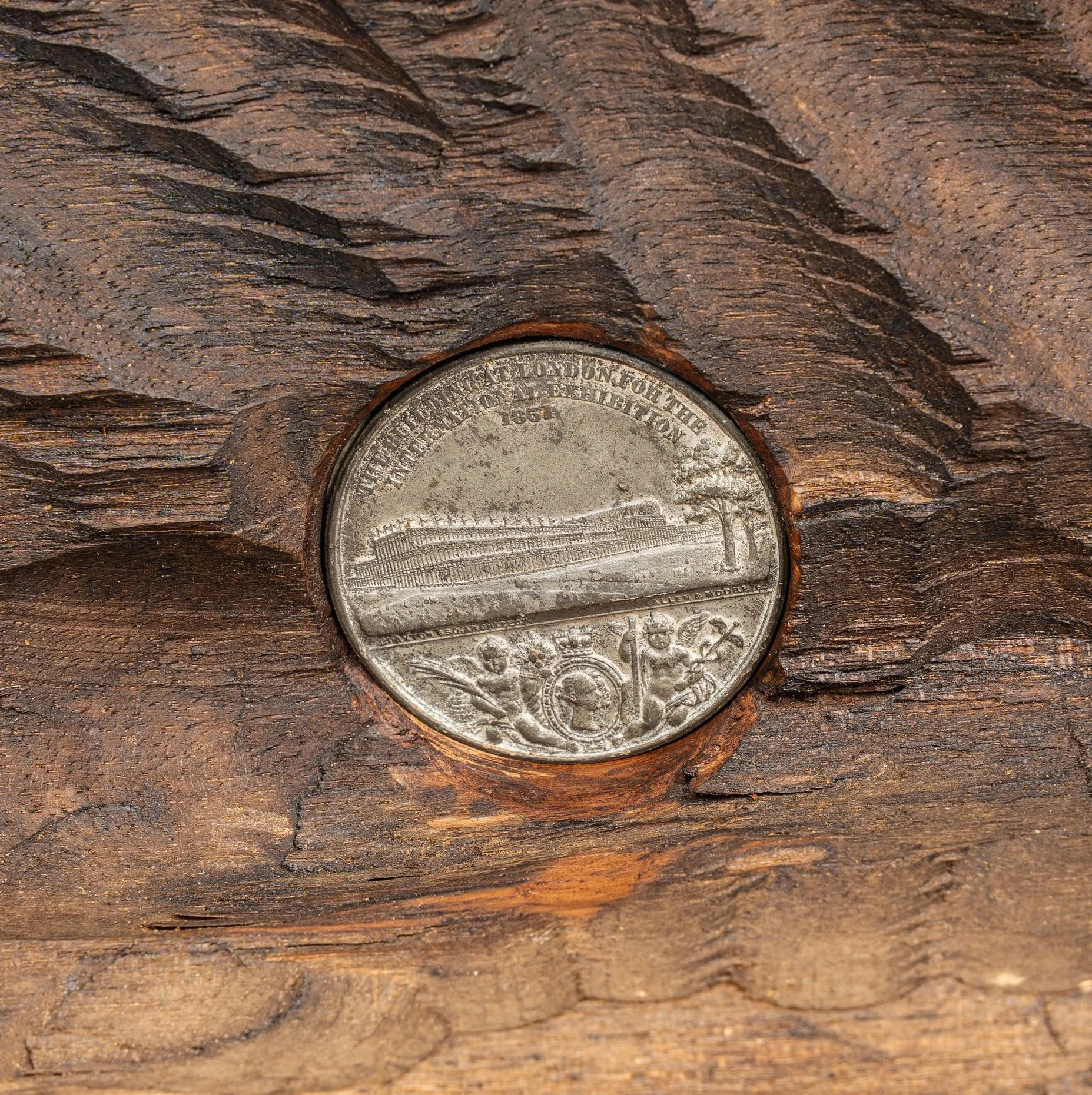 Great Exhibition 1851 medal with Crystal Palace, set into the base of a Brienz carved walnut group — Daniels Antiques