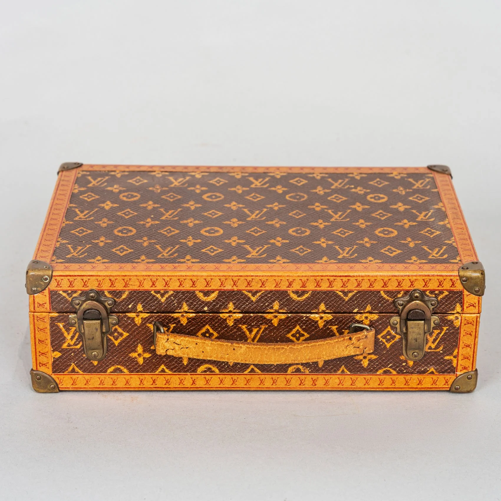 Louis Vuitton monogram jewelry case, early 20th century, brass clasps and vachetta leather handle, exterior view