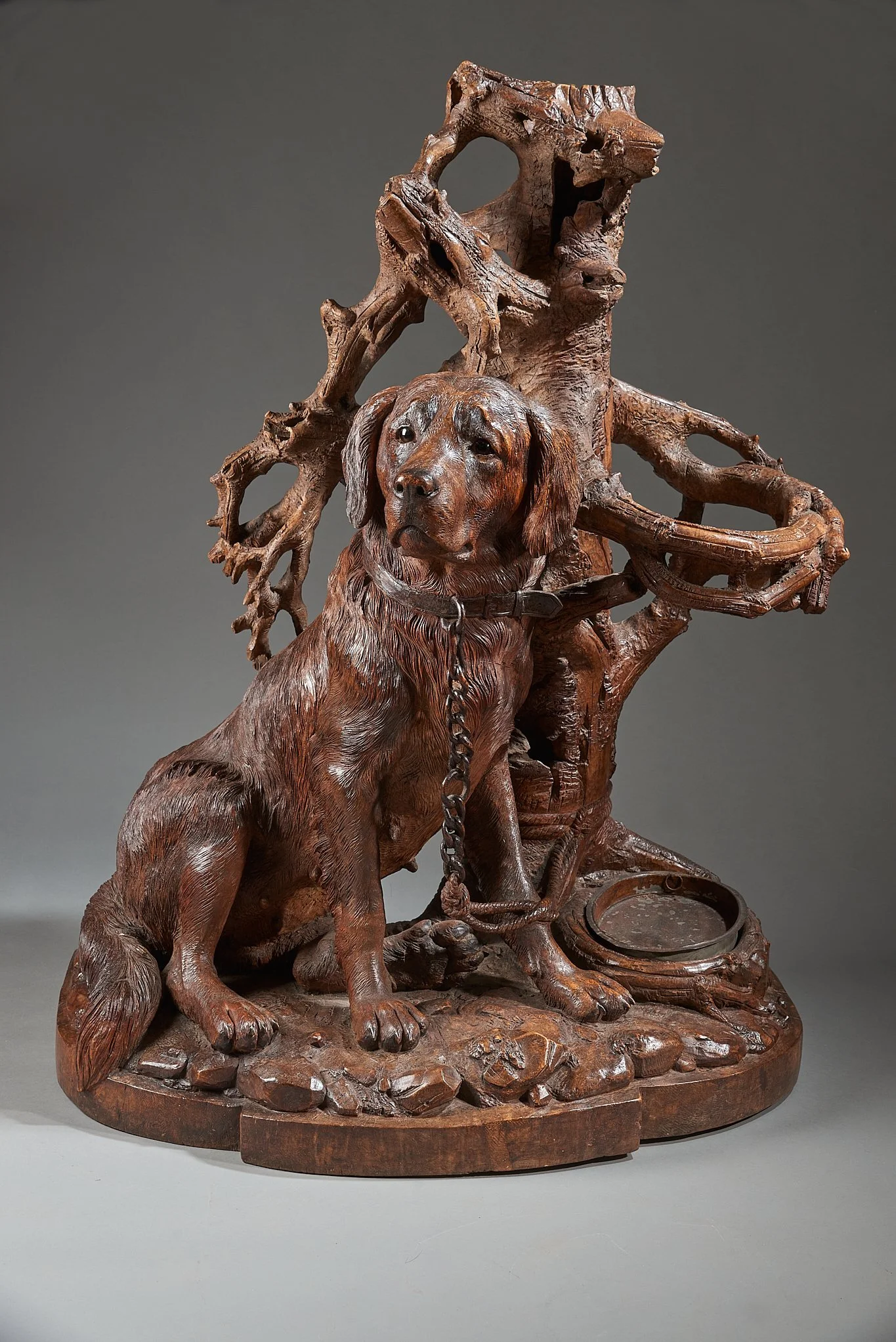 Swiss Black Forest carved walnut dog umbrella stand, Brienz, circa 1880. Illustrated in Swiss Carvings: The Art of the Black Forest, 1820–1940, plate 00.