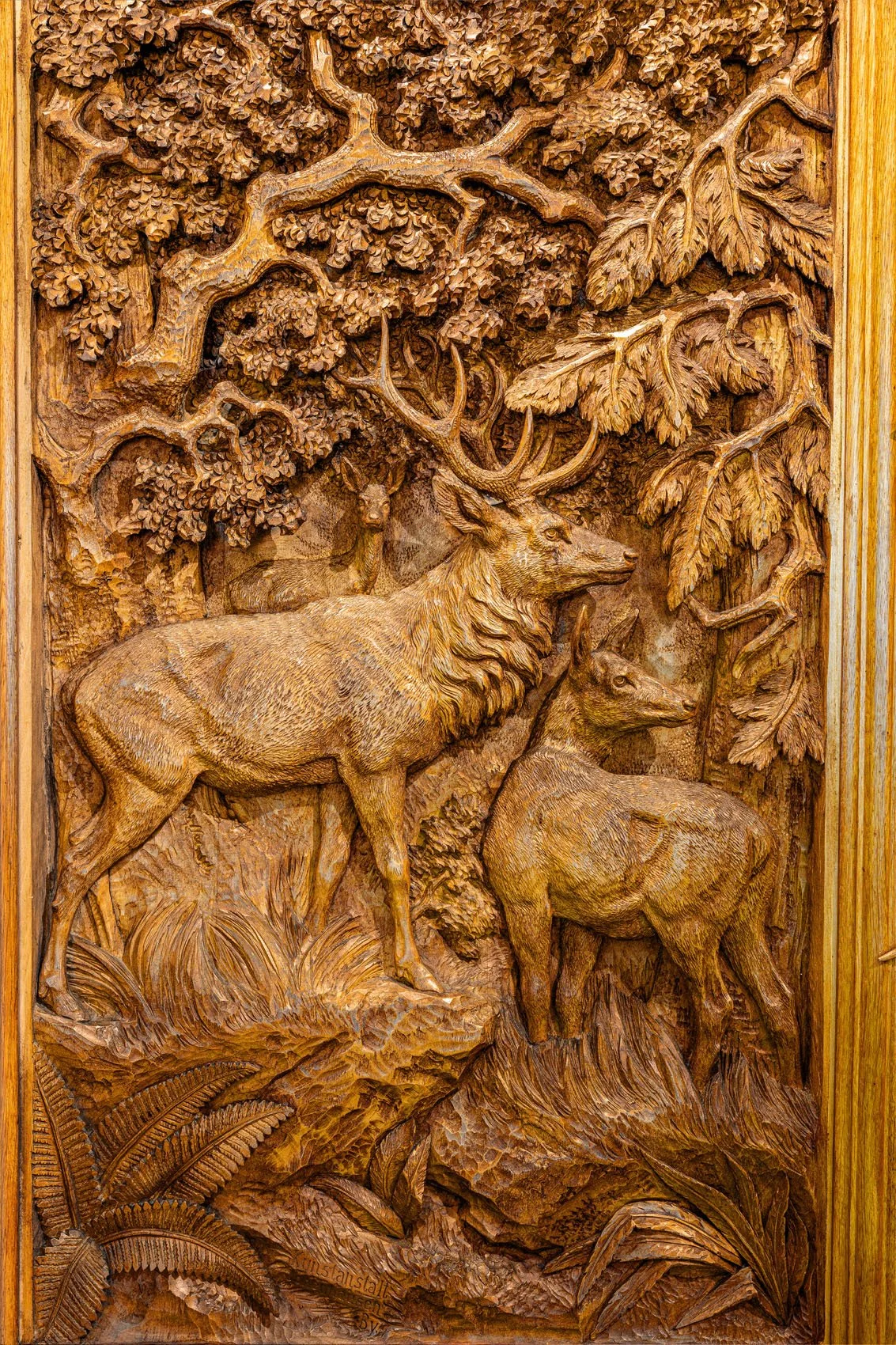 Full view of carved high-relief stag and hind panel, Black Forest Jagdschrank, Brienz late 19th century