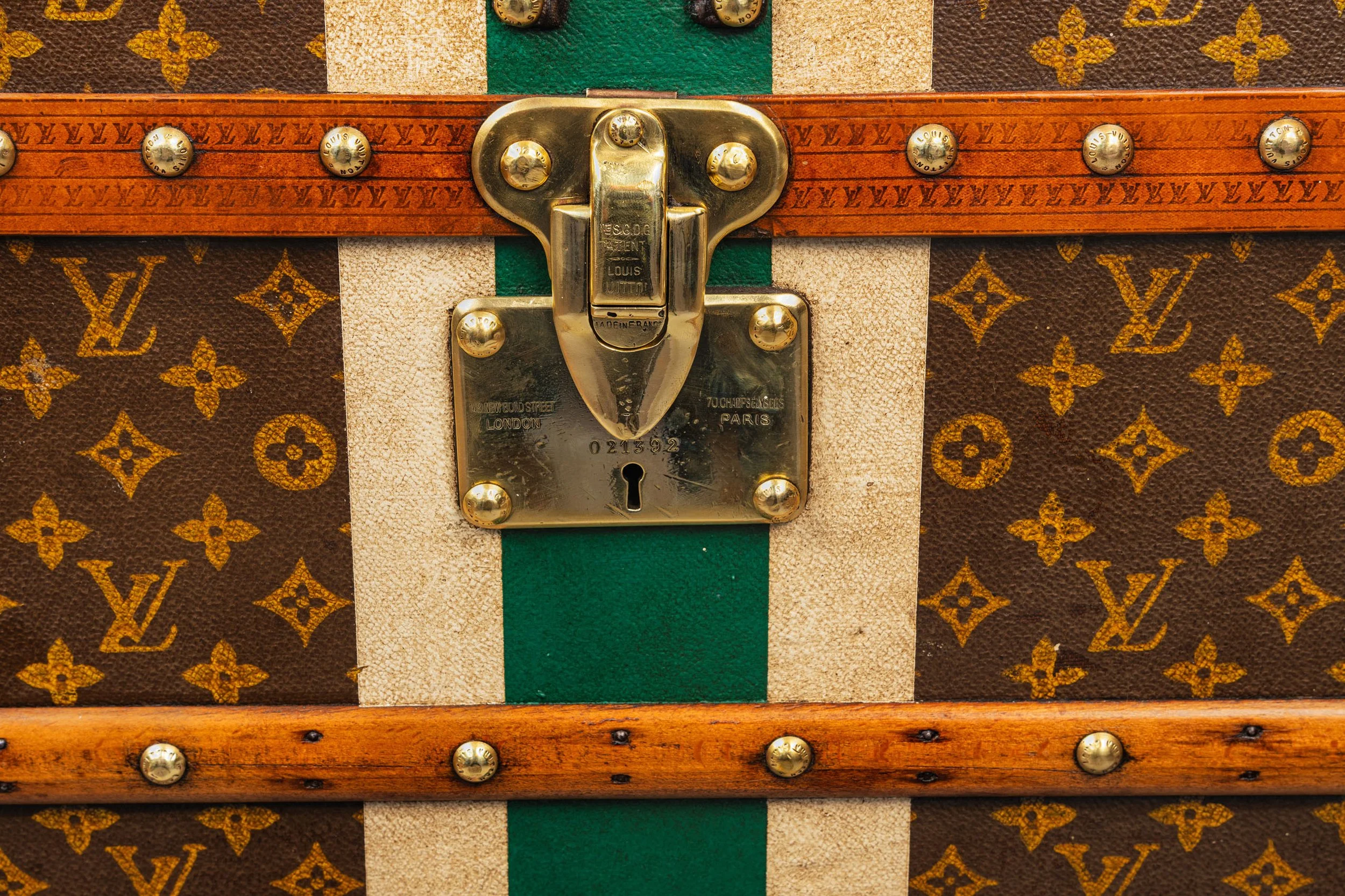 Louis Vuitton brass lock detail on monogram canvas trunk