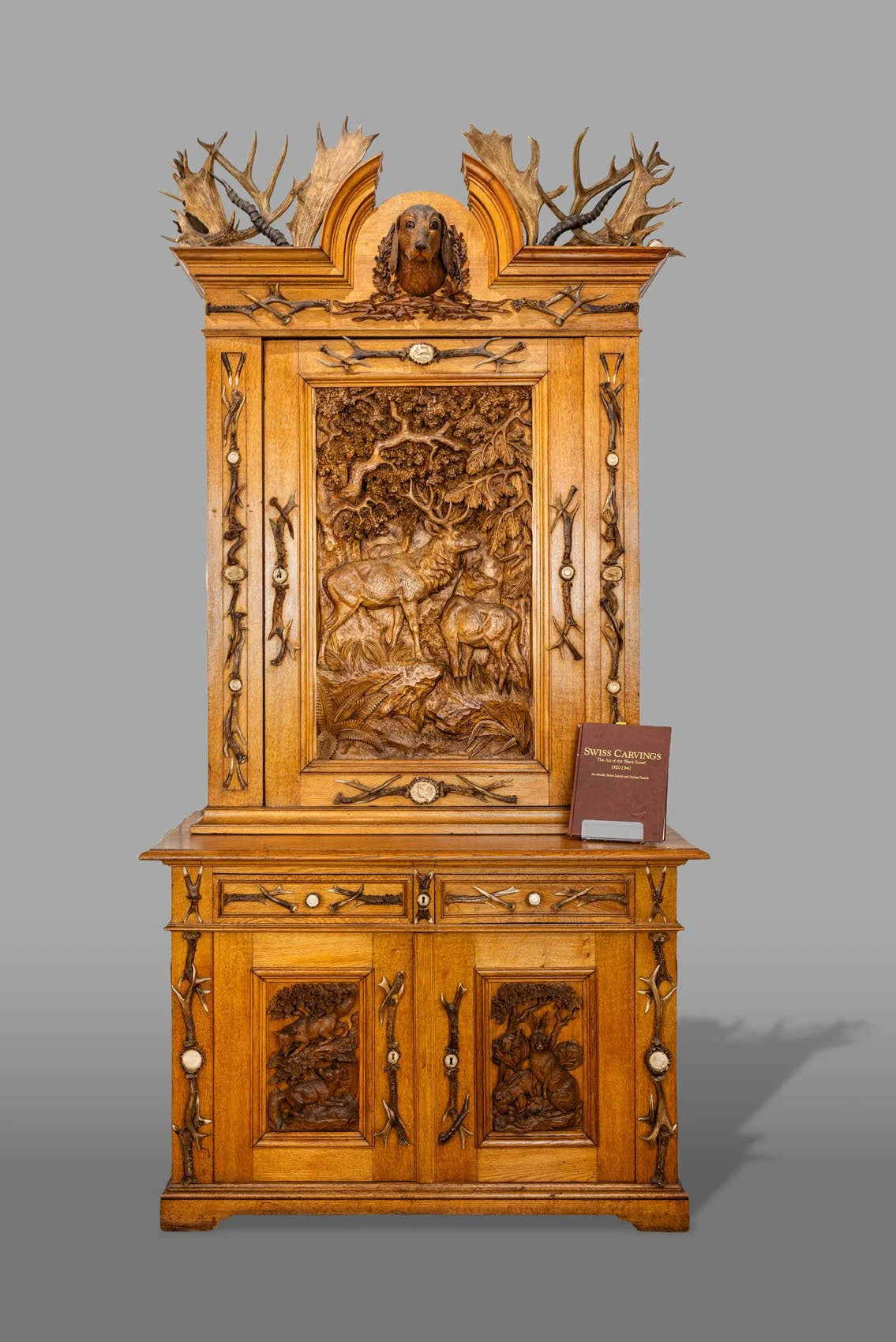Black Forest Antler-Mounted Hunting Cabinet (Jagdschrank), Oak with Carved High-Relief Panels and Stag Horn Mounts, Late 19th Century