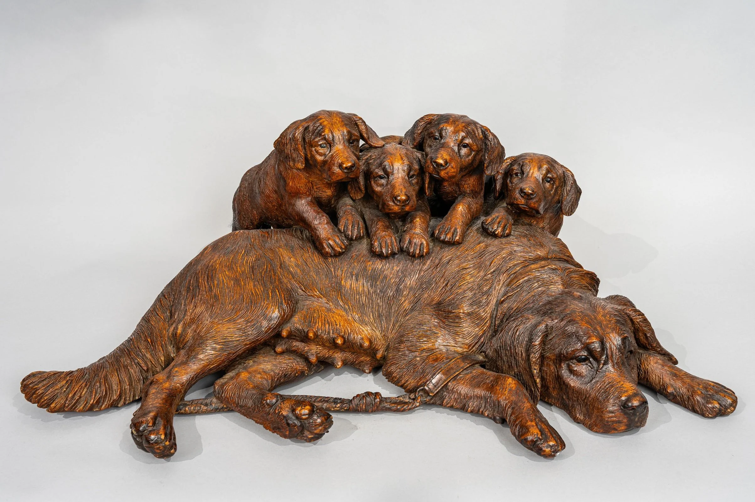 Side view of Swiss Black Forest carved walnut hound and four pups group, Walter Mader, Brienz circa 1870