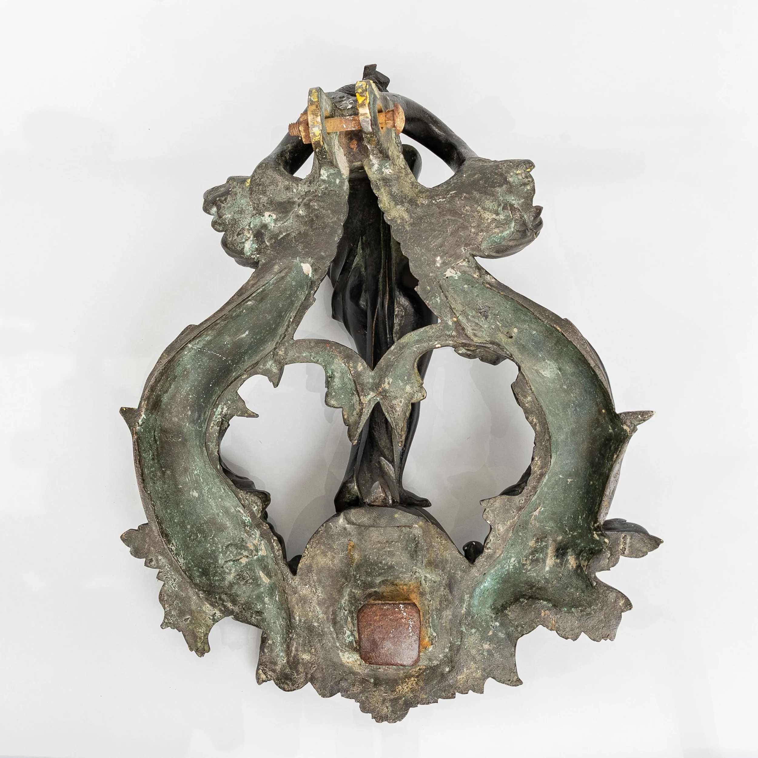 Reverse of an antique bronze door knocker showing green corrosion and forged iron striker — Daniels Antiques