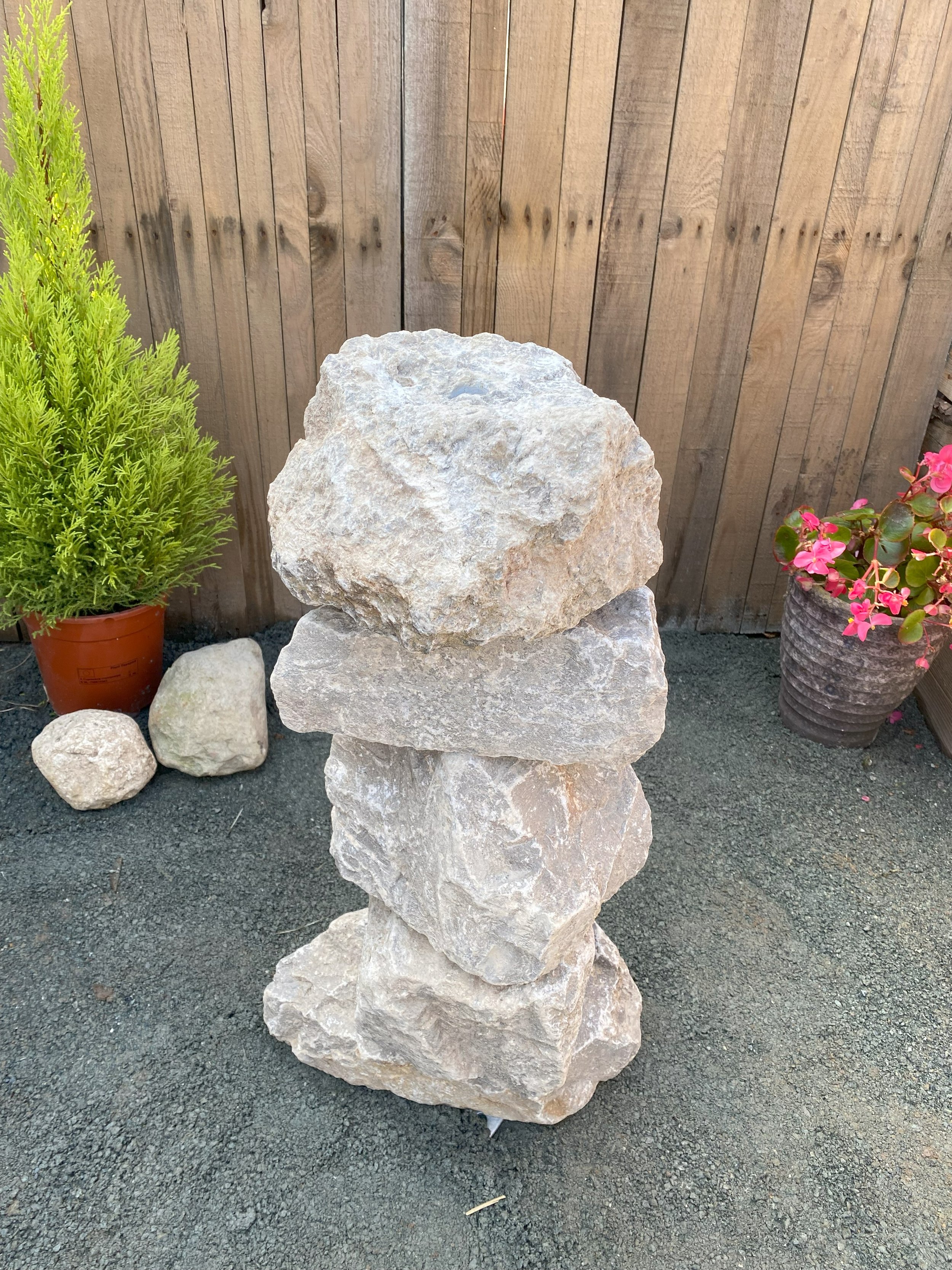 small drilled highland grey limestone stack in front of fence panelling
