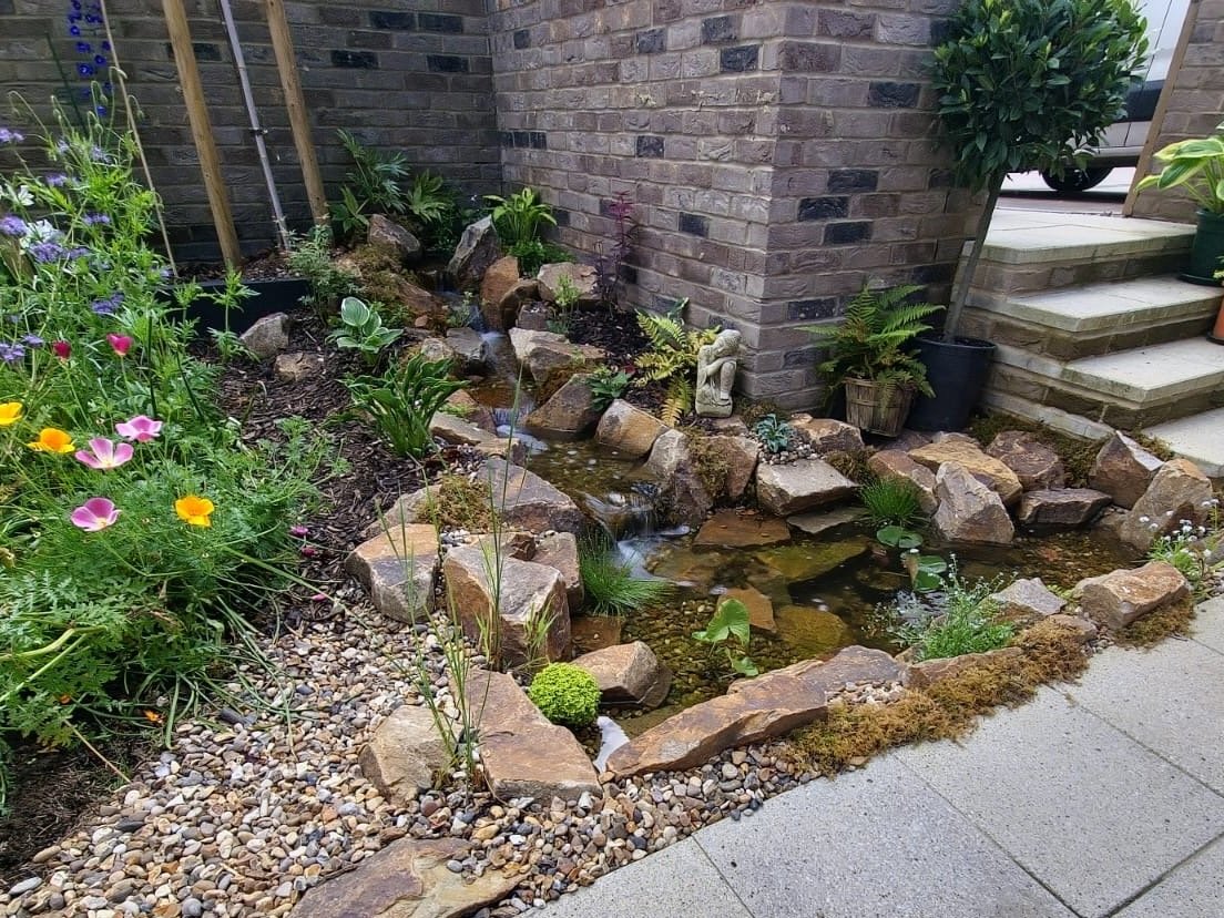 golden granite waterfall and pond in garden (Copy)
