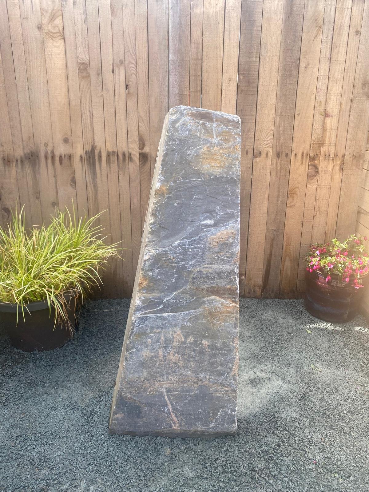 3ft grey Welsh slate monolith in front of wooden fence panel
