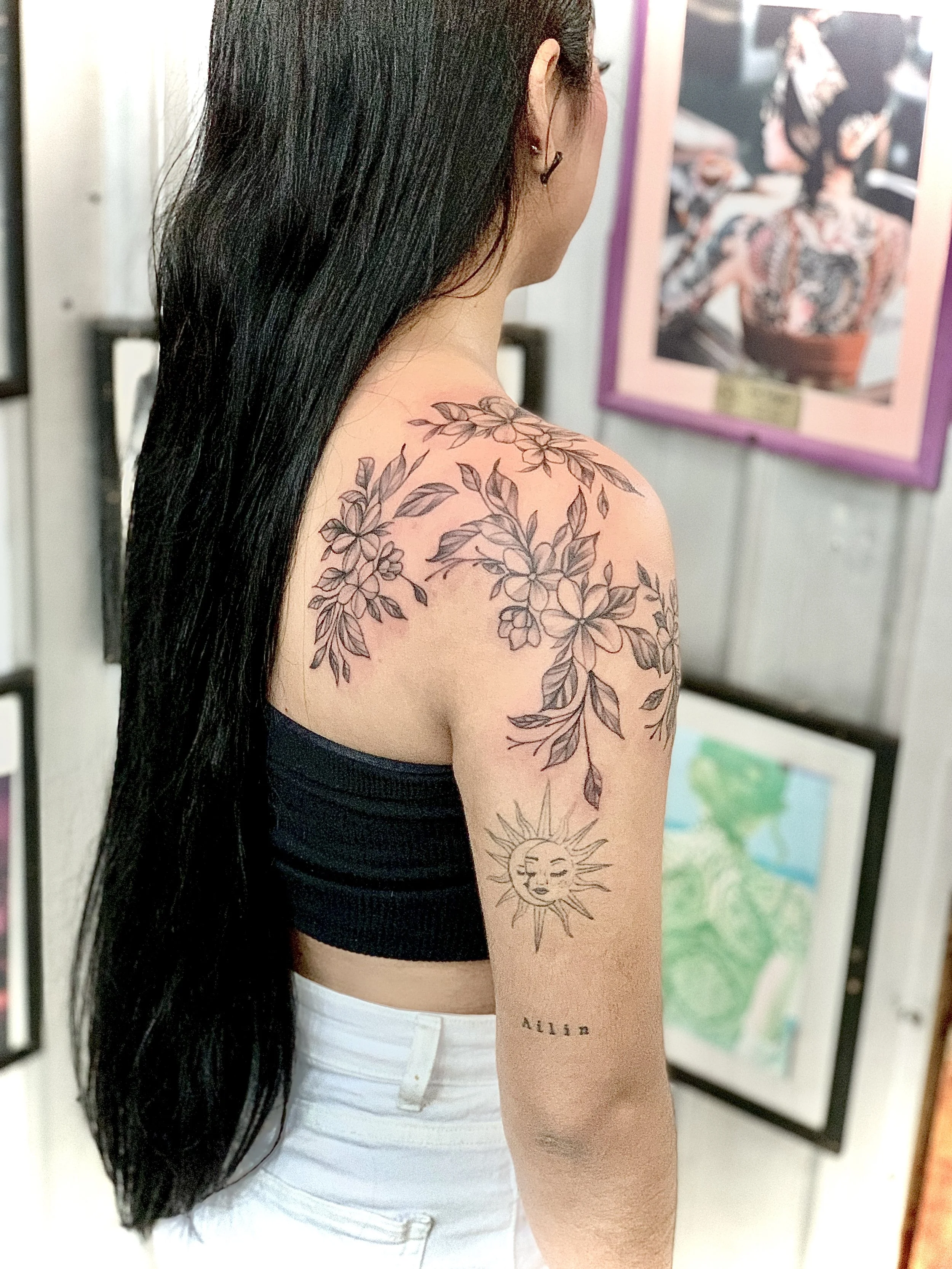 Flowers on woman tattoo by kidd in cabo activity