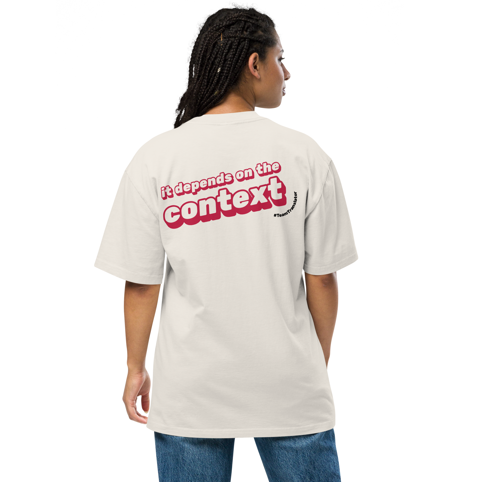 Person showing their back wearing an oversized t-shirt in cream colour that has the "it depends on the context" slogan in a straight line and the text "#TeamTranslator" in a semi circle.