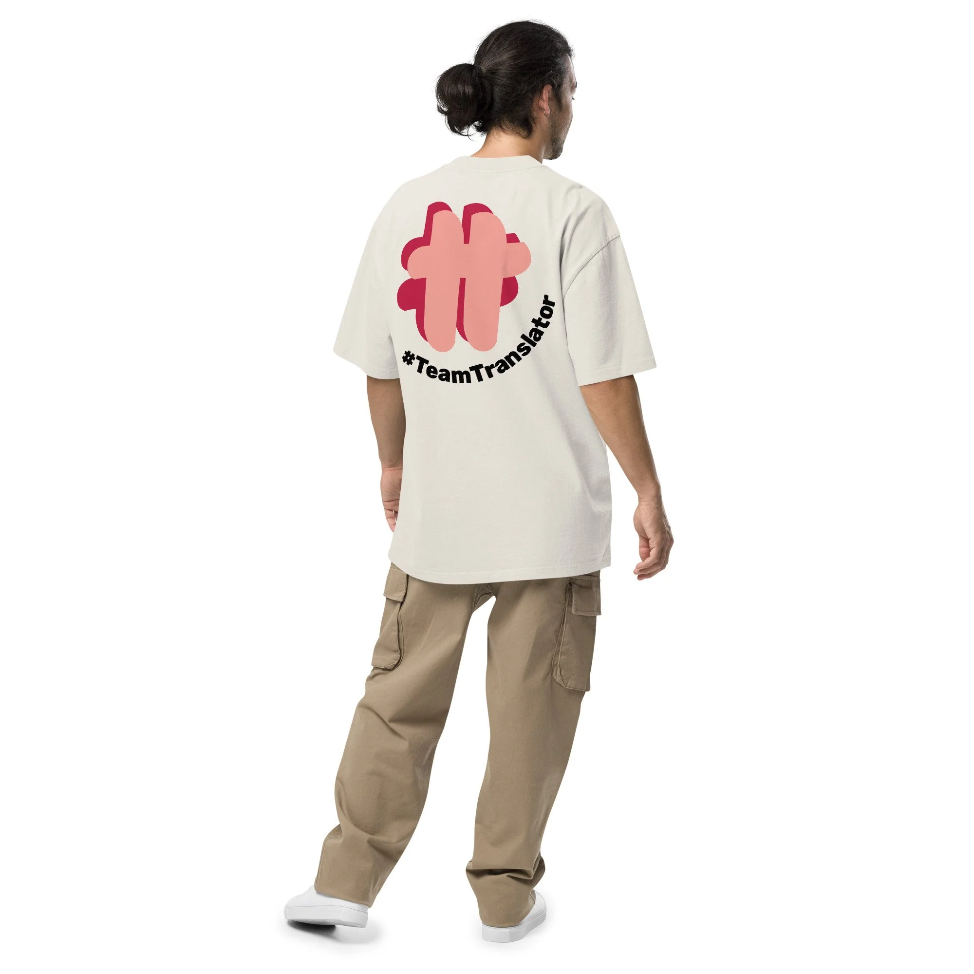 Person showing their back wearing an oversized t-shirt in cream colour that has a large #TeamTranslator logo on the back.