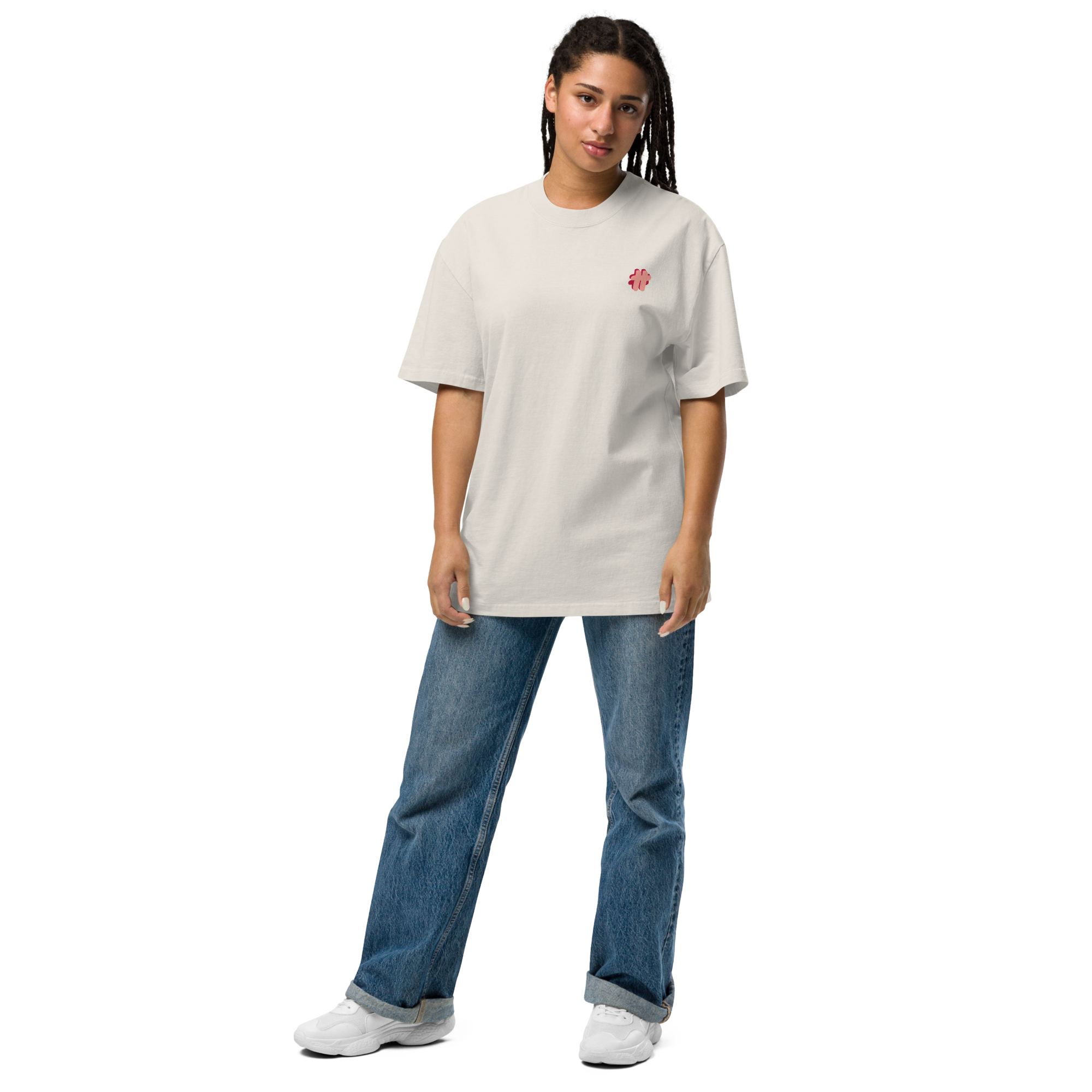 Person in sunglasses wearing an oversized t-shirt in cream colour that has a small #TeamTranslator logo on the left side of the chest.