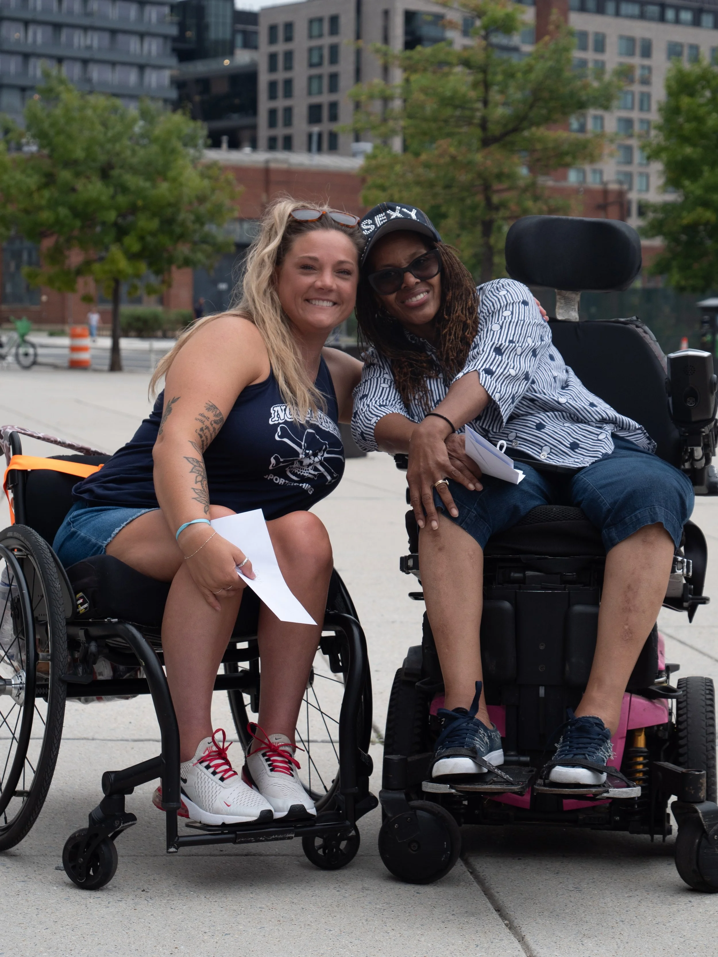 Two wheelchair users smile together outside Nationals Park