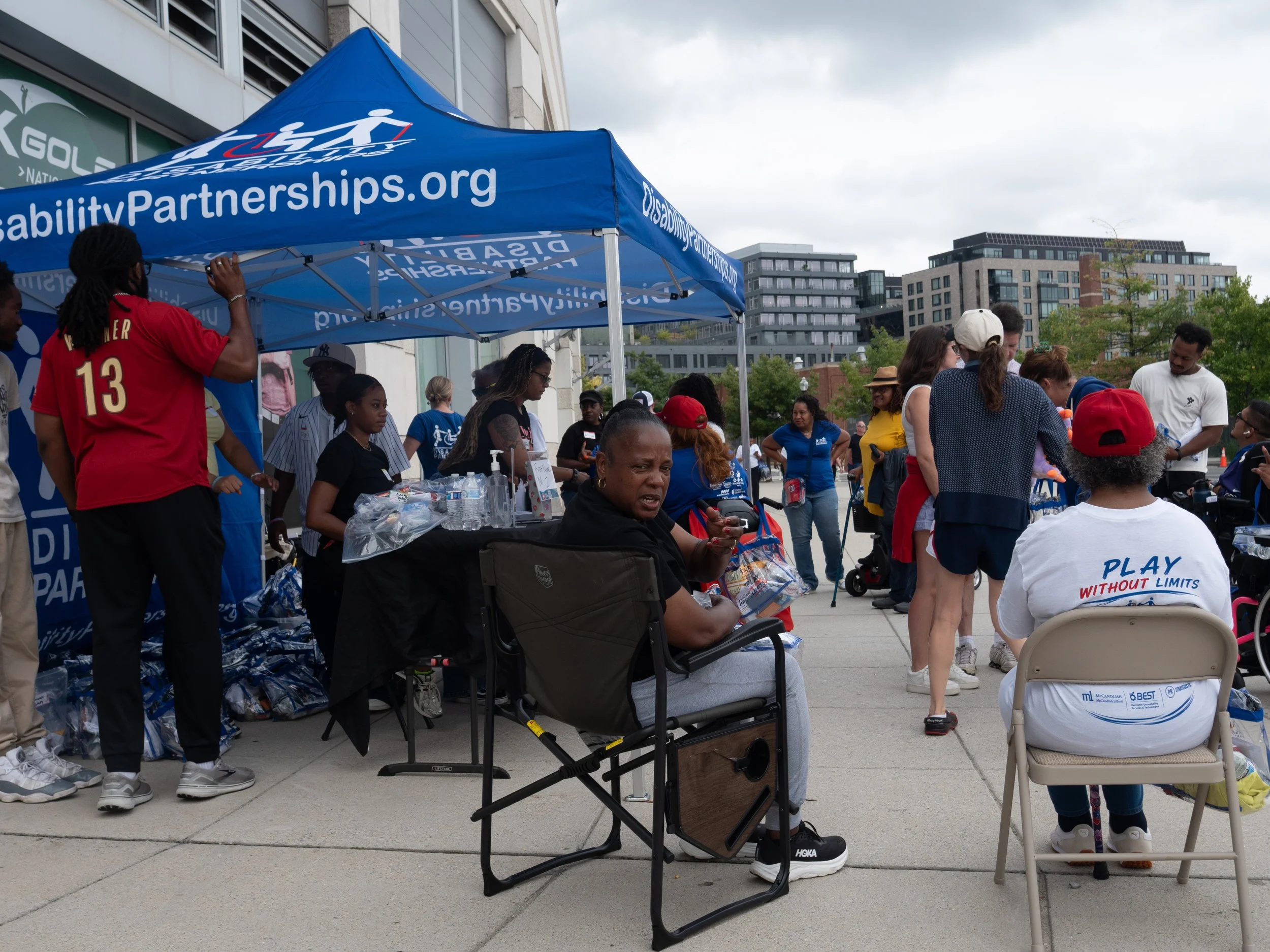 Attendees and volunteers gather at the Disability Partnerships welcome tent outside Nationals Park
