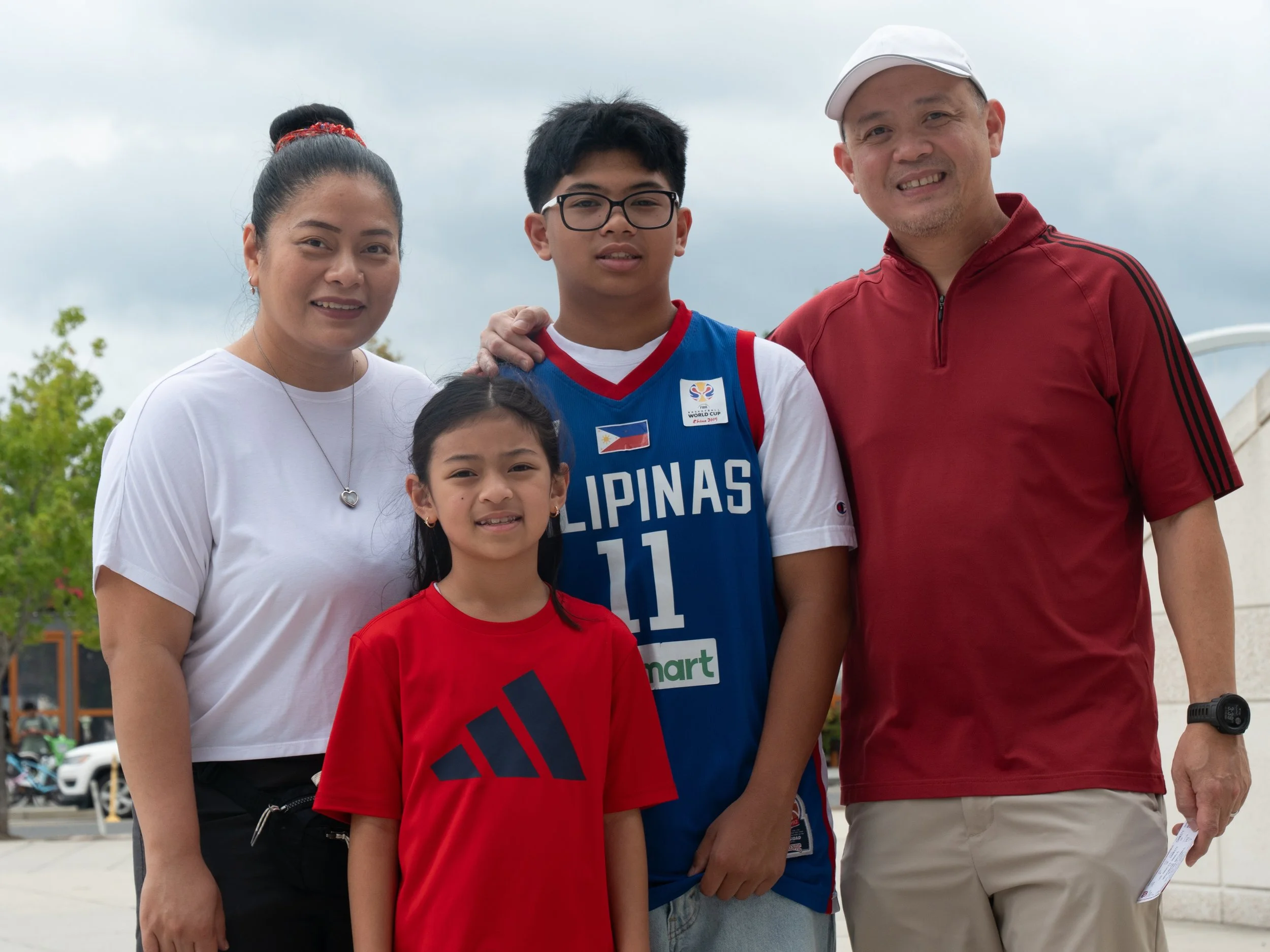 Family of four poses together outside Nationals Park during Play Without Limits