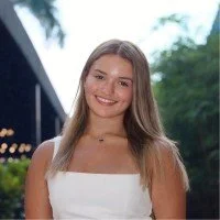 Young woman with long hair smiling outdoors