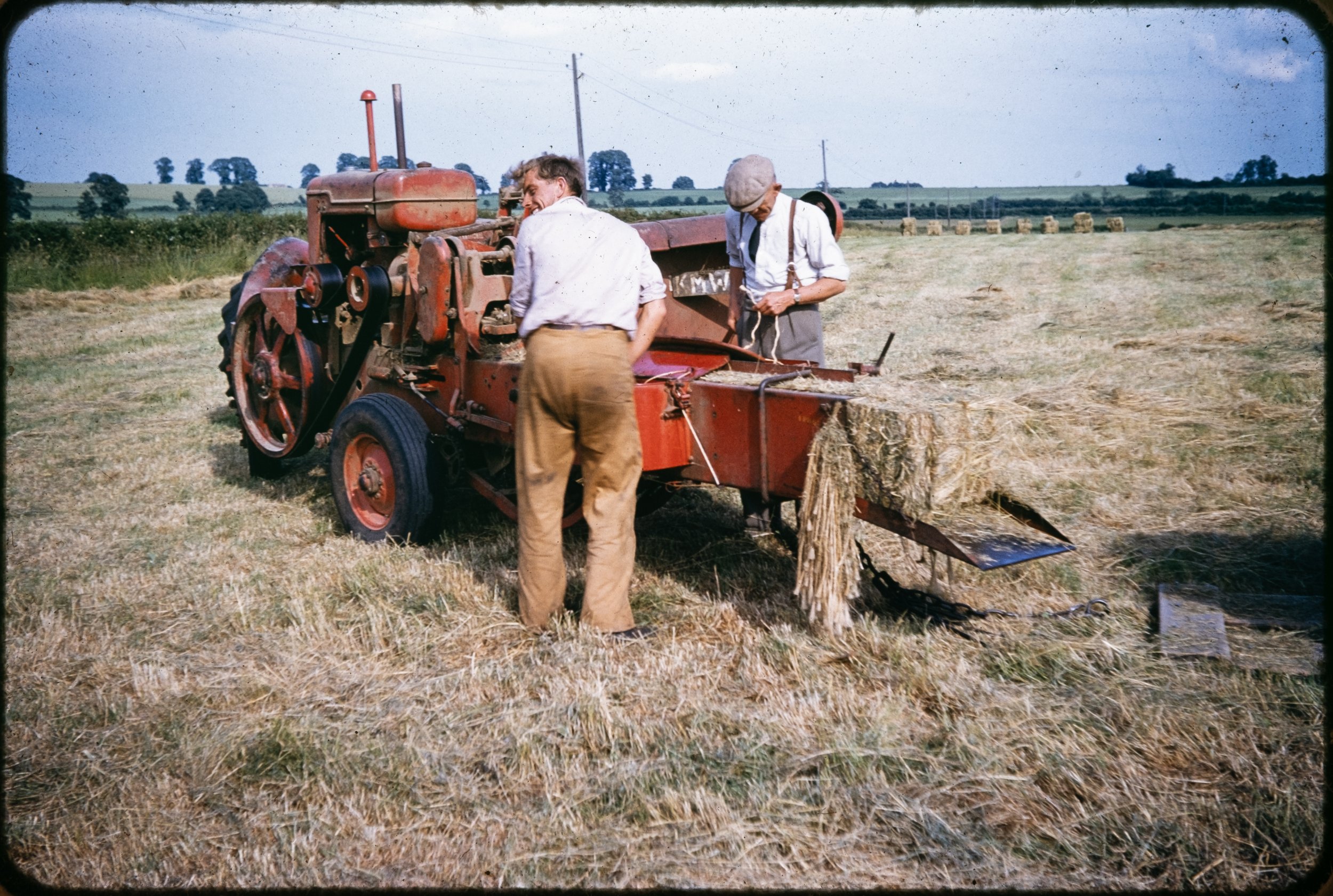 My Grandfather fixing the hay baler, a mechanical mind is always important on the farm.
