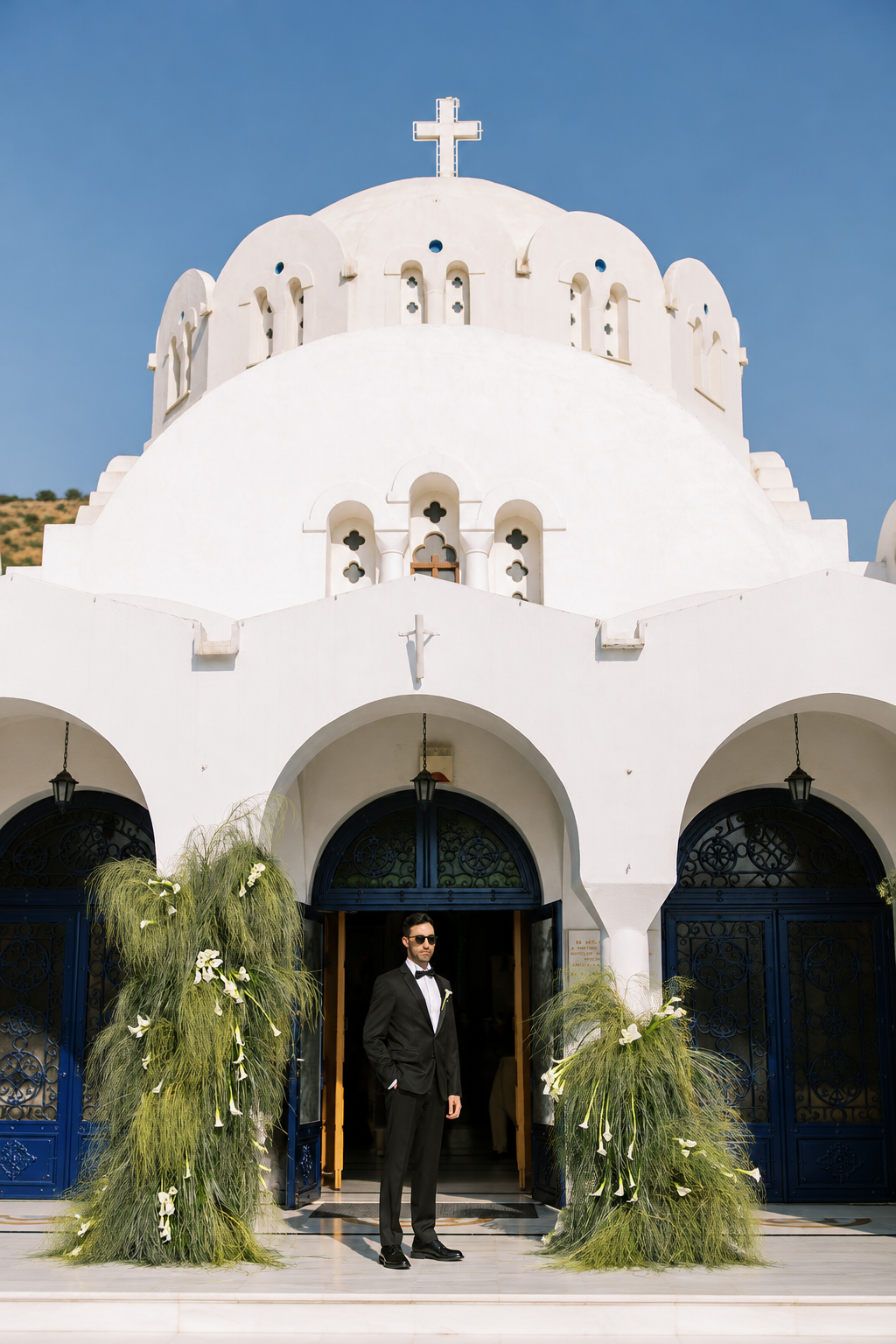 groom waiting for bride at the church, with green grass decoration 