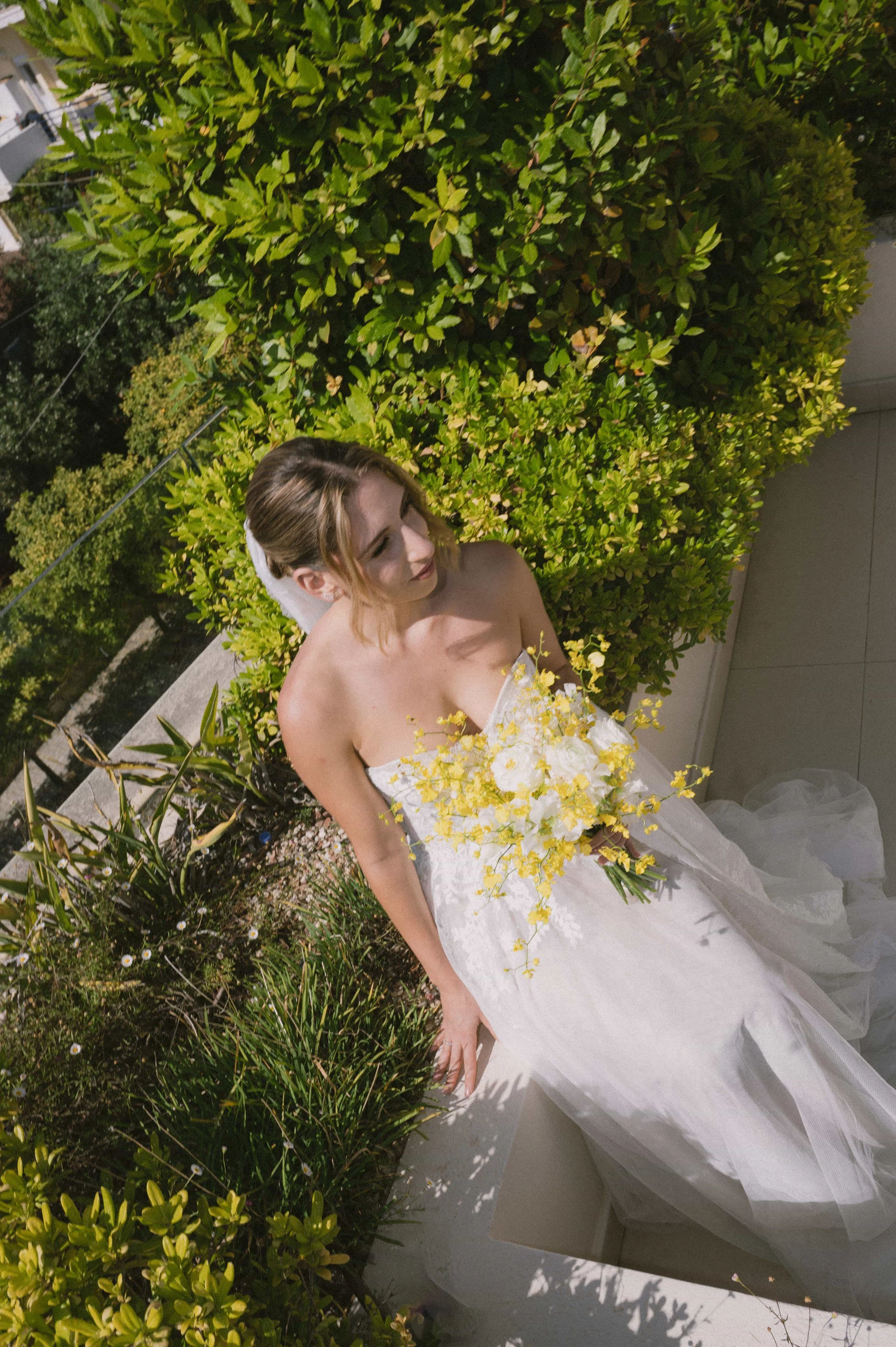 bride posing with yellow bouquet