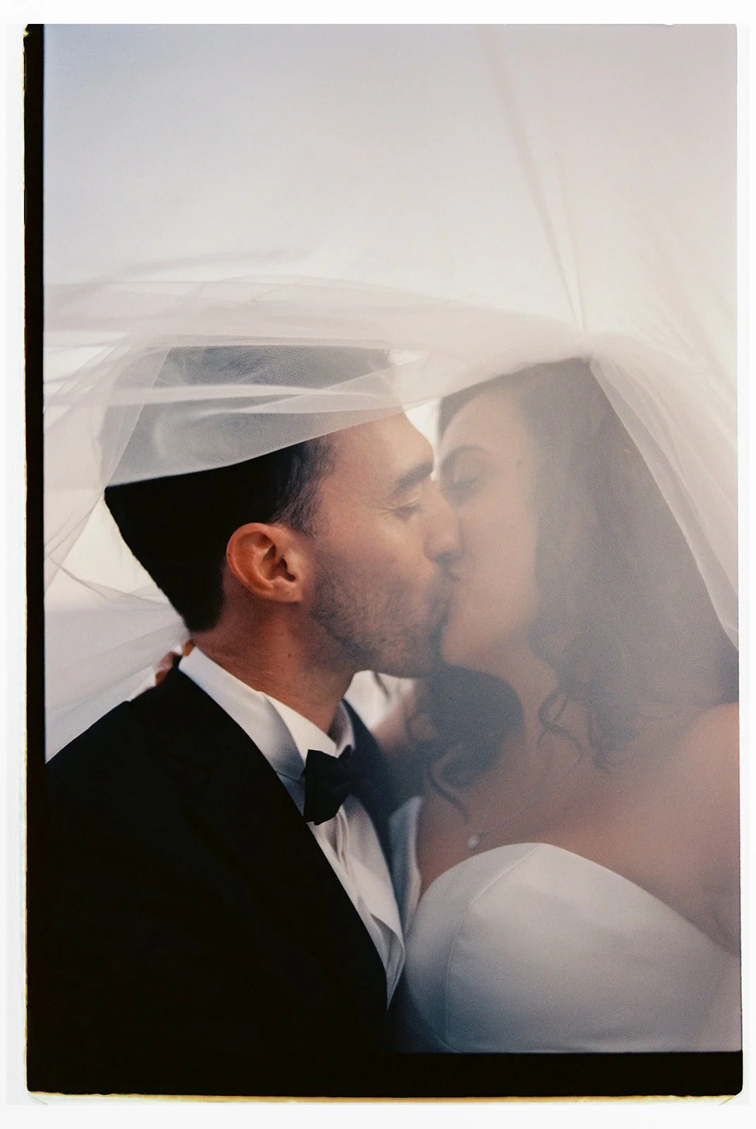 couple kissing under the veil