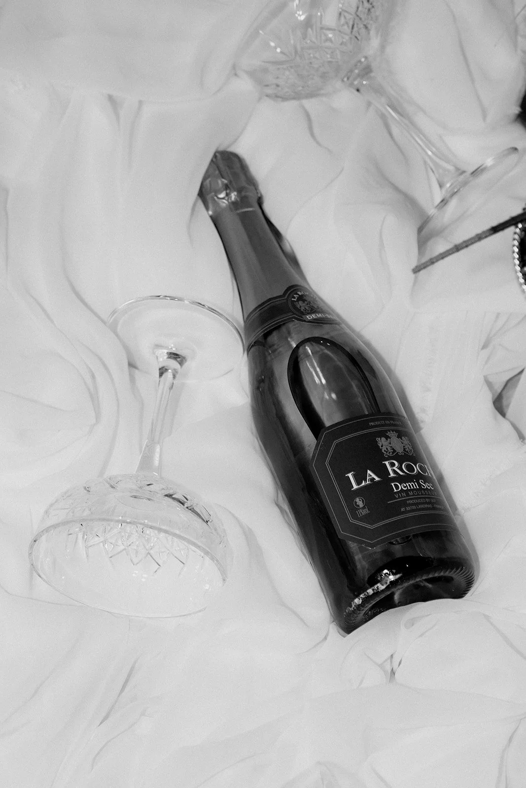 black and white champagne and glasses in white drapery 