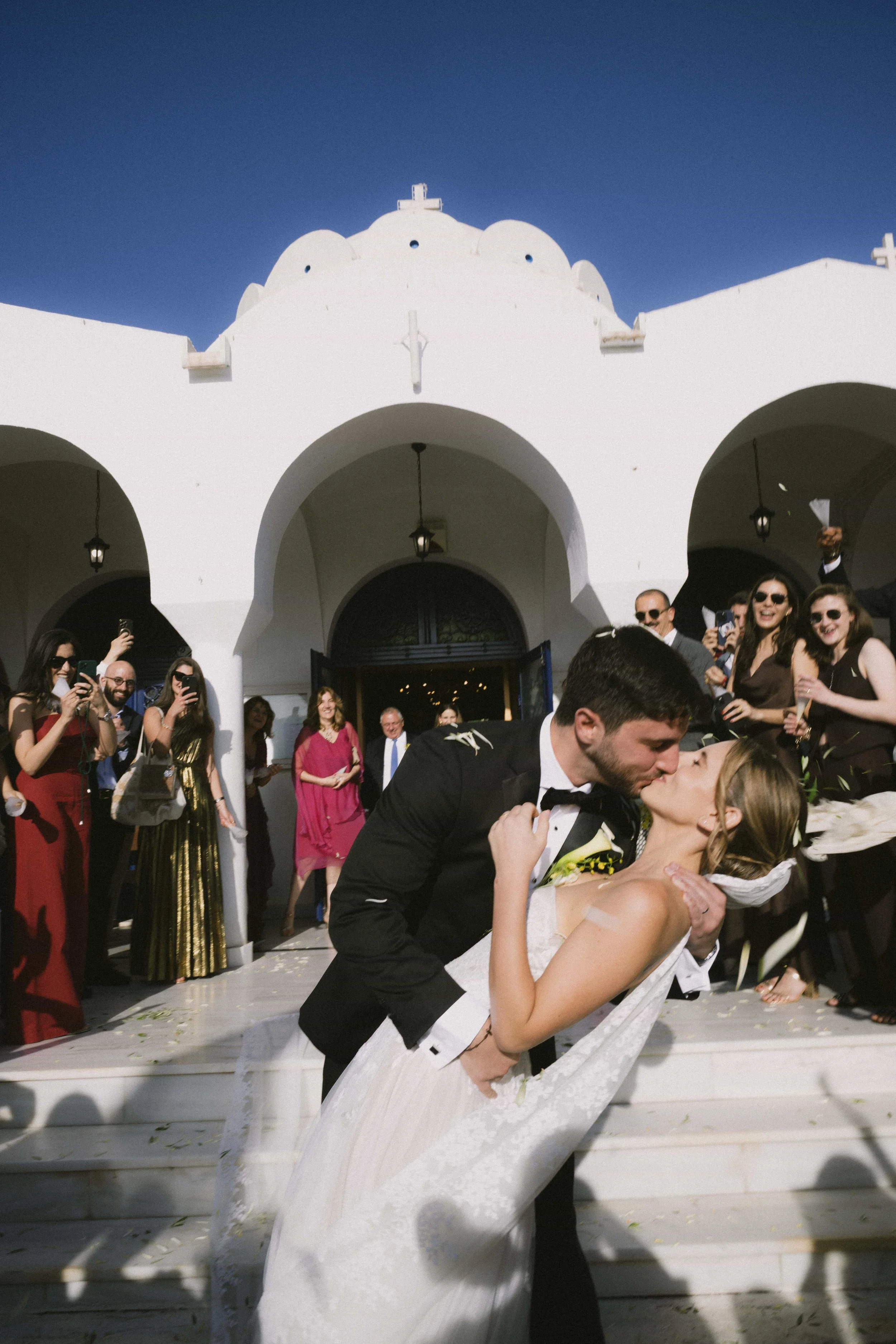 couple kissing in front of church