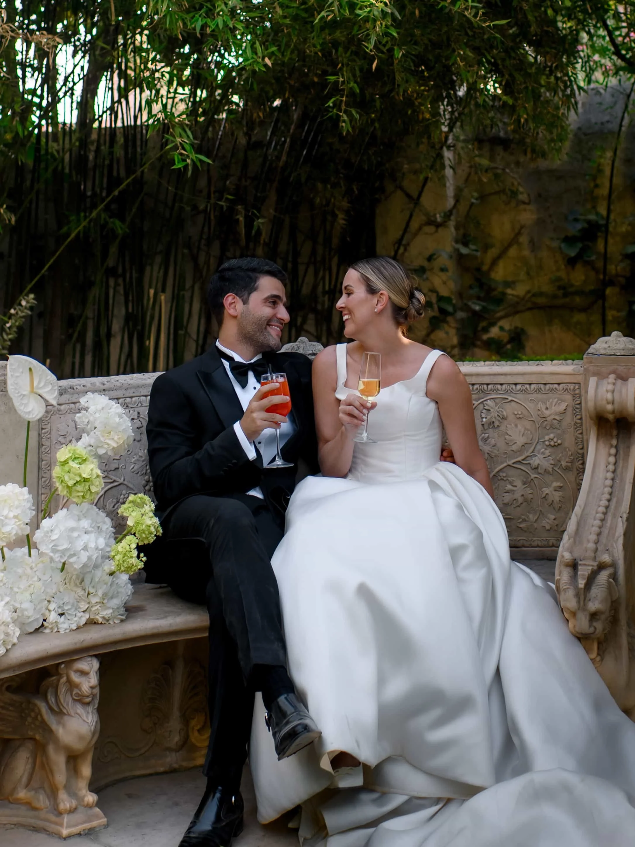 couple on an italian bench with white hydrangeas 
