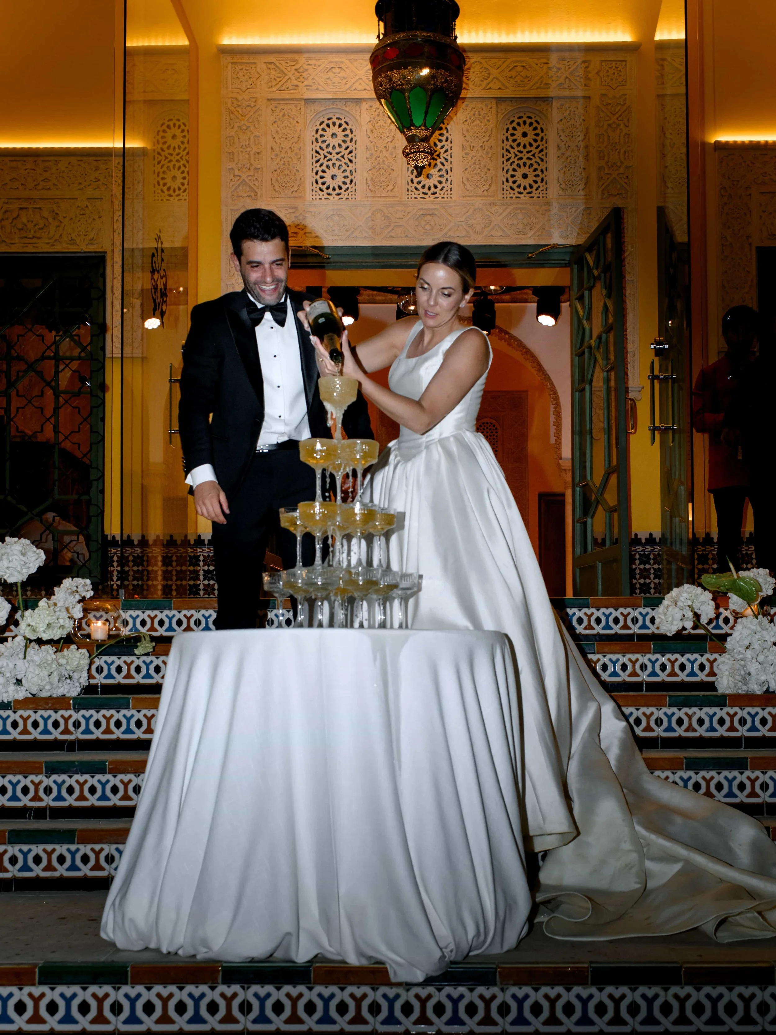 couple pouring champagne tower 