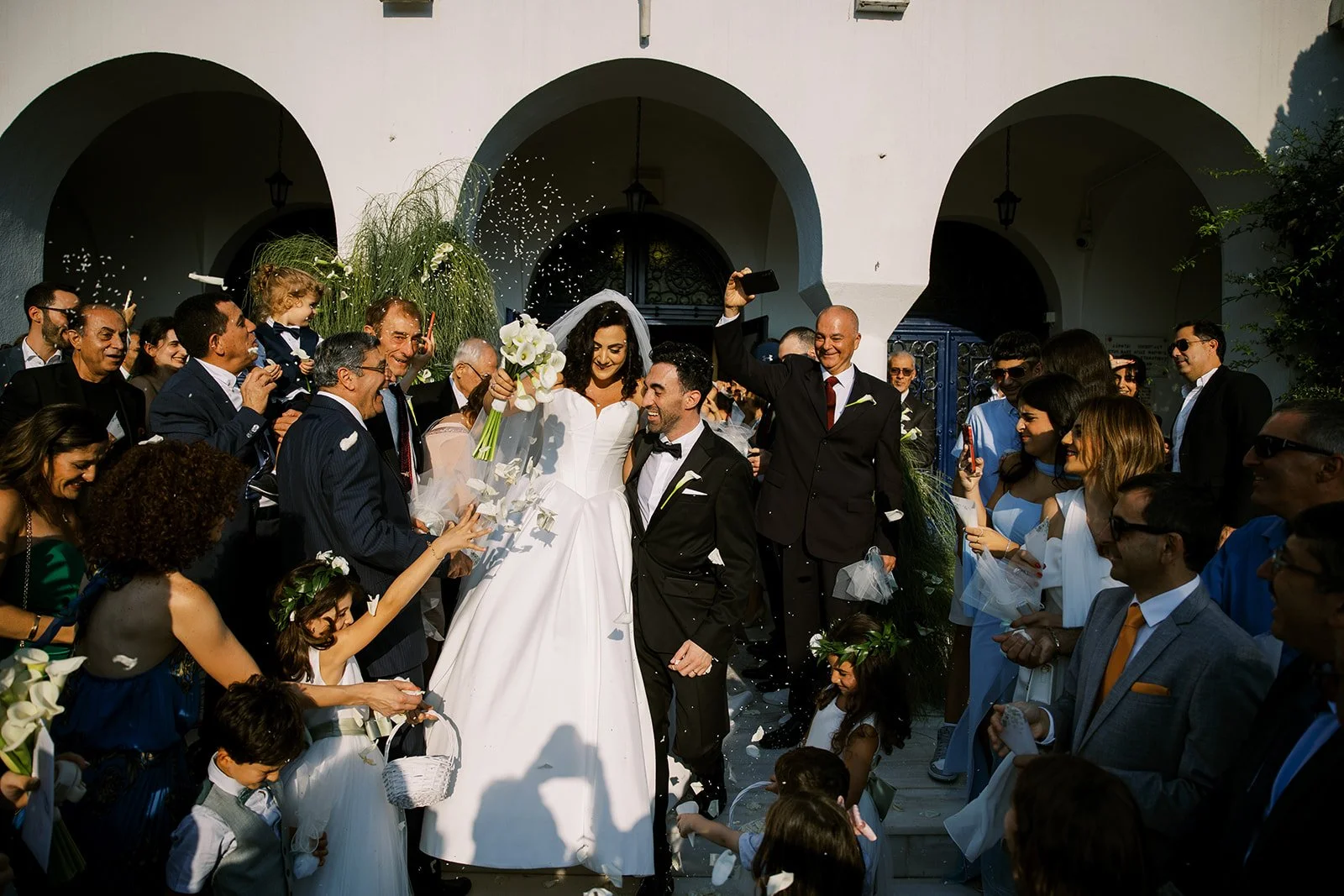 couple exiting and guests throwing rice at them 
