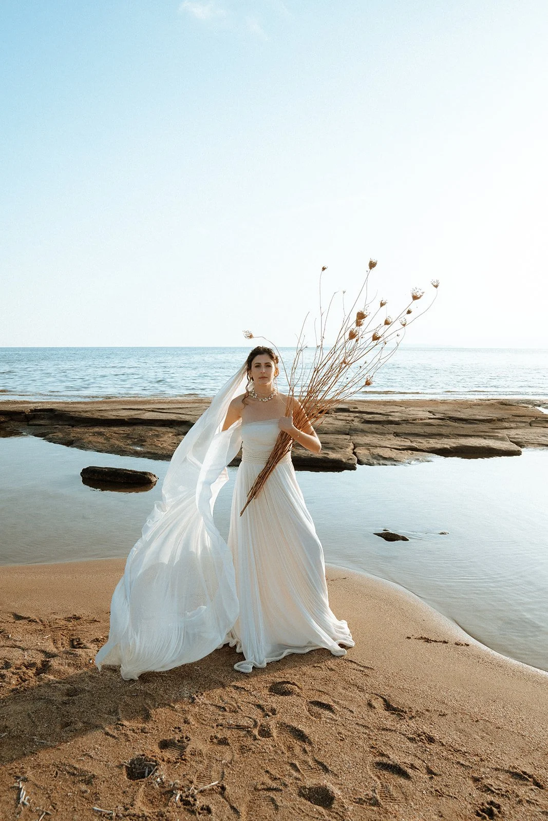 bride posing on a greek beach