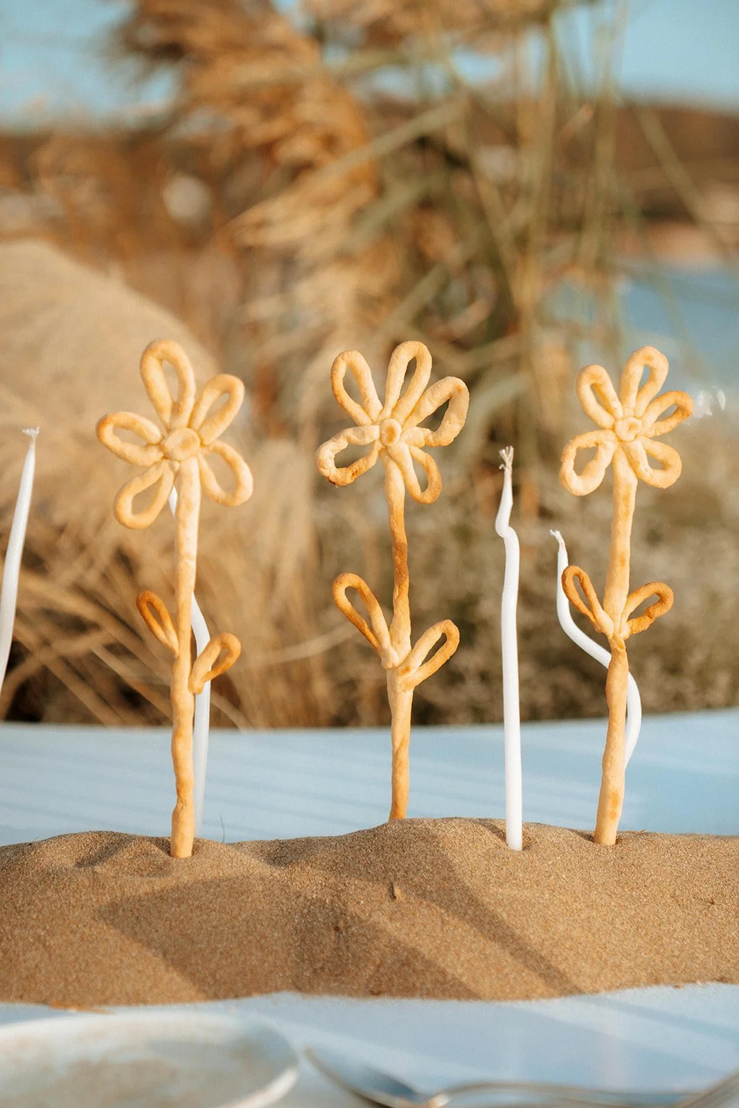 bread sticks in a flower shape and twisted candles