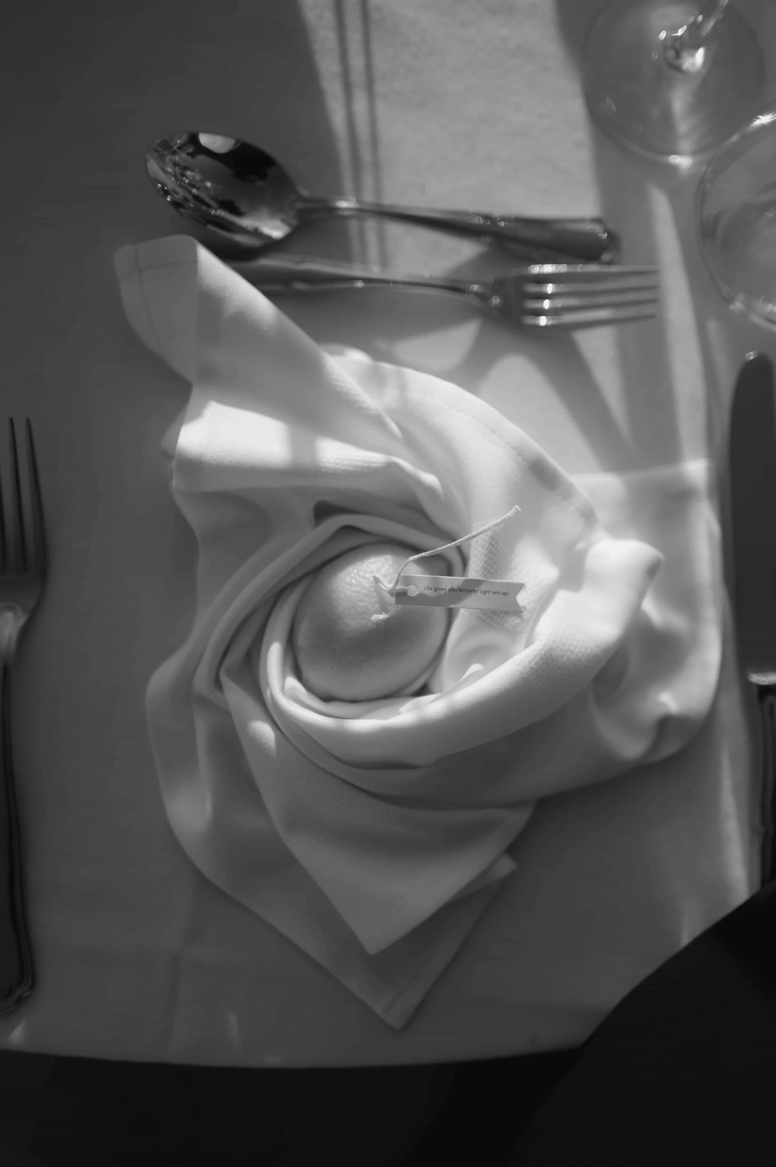 lemon candle favor wrapped in a white napkin