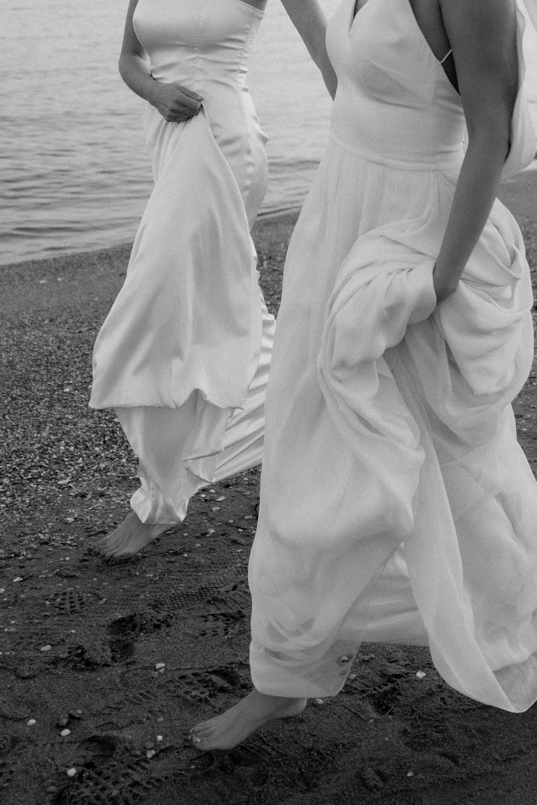 close up on 2 brides walking on the beach, fabric close up
