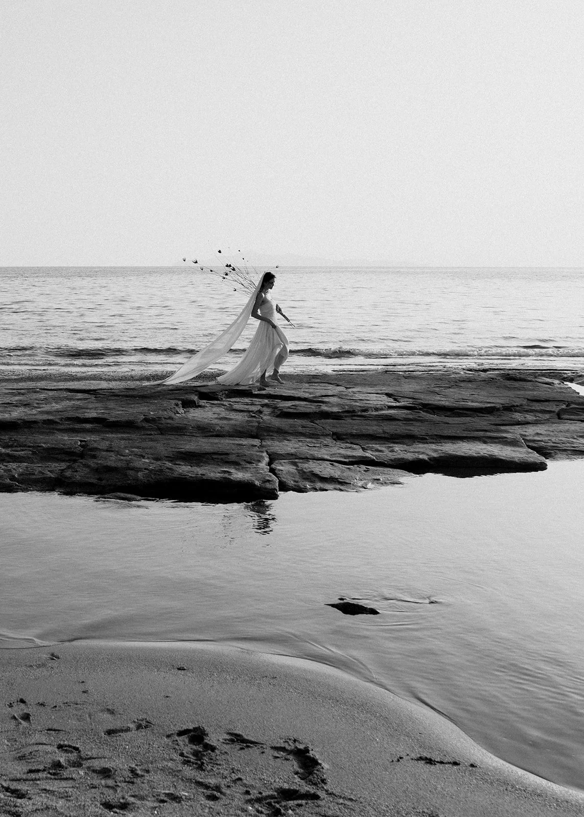 bride walking on the sea black and white