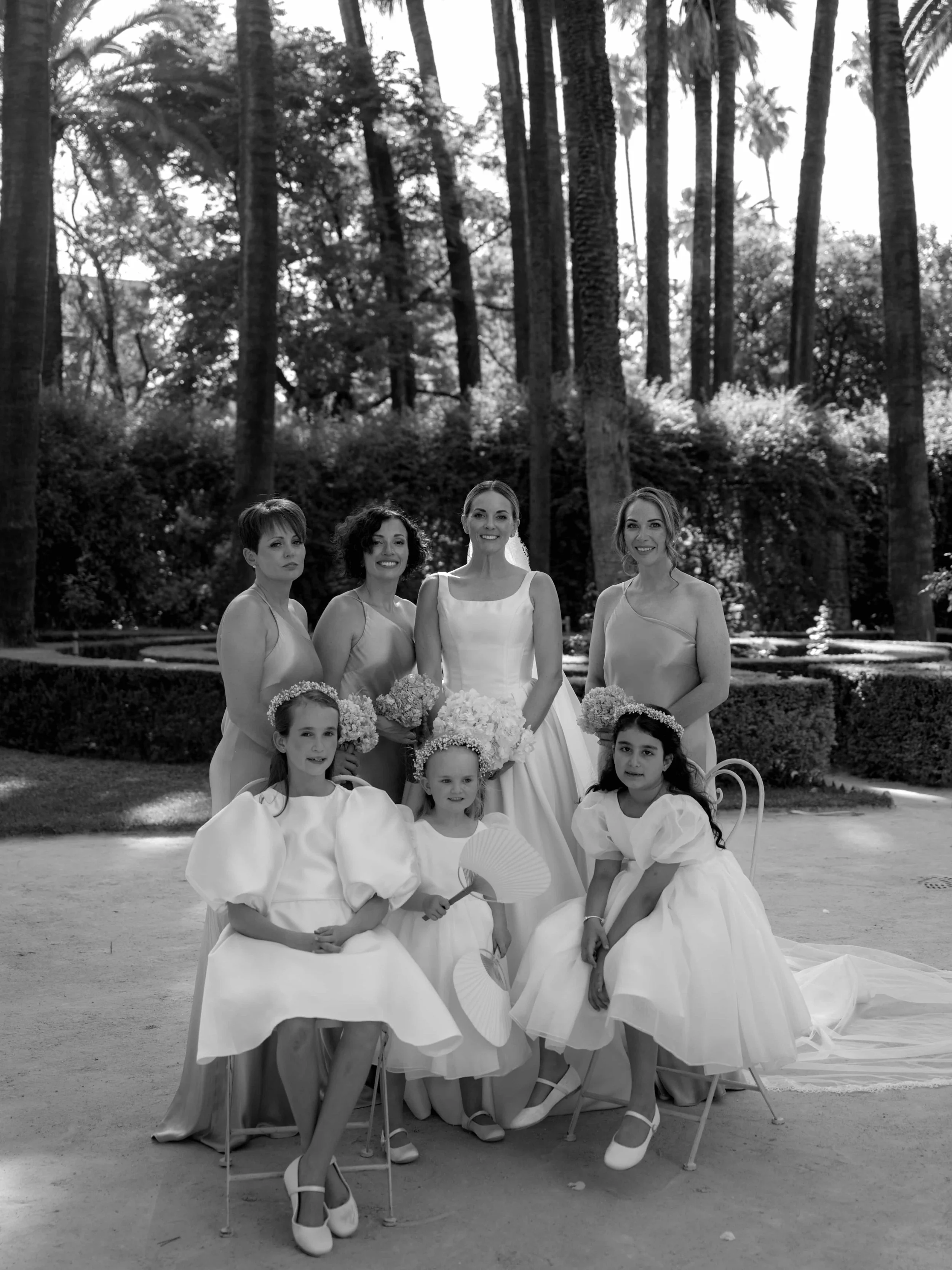 bride and bridesmaids and flower girls black and white picture 