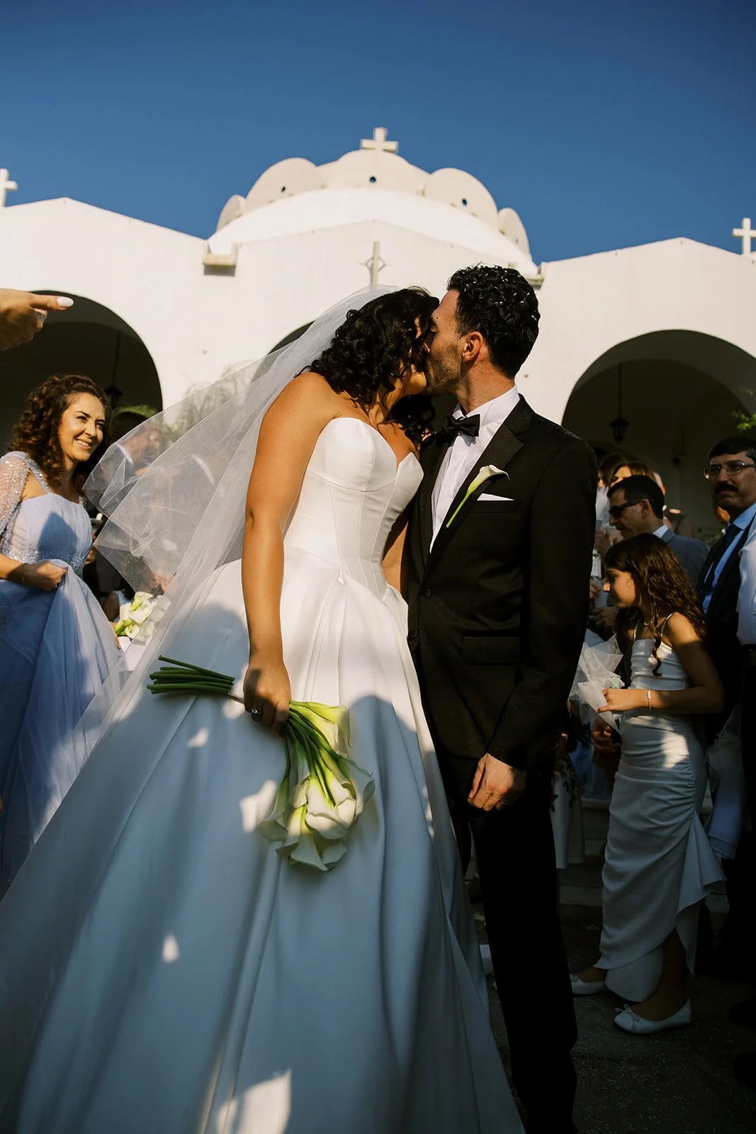couple kissing outside the church 