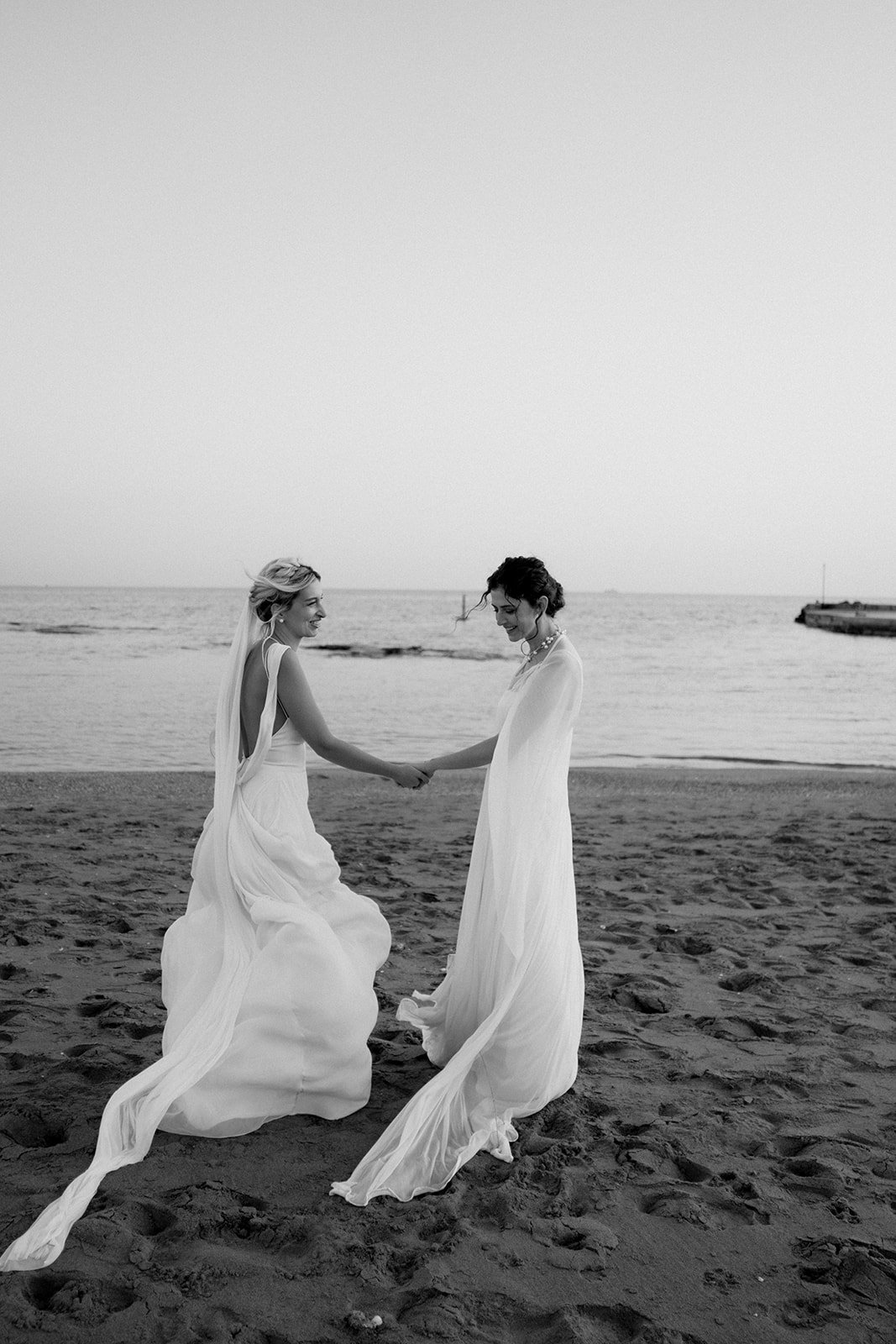 same sex couple photoshoot on the beach in black and white 