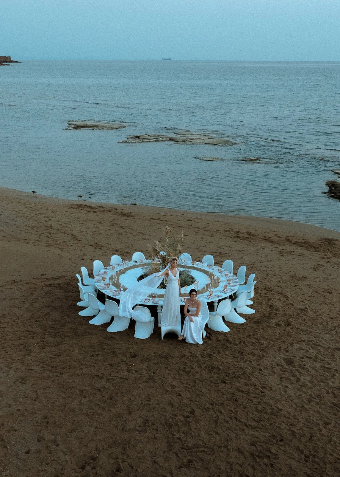 2 brides posing on a wedding table