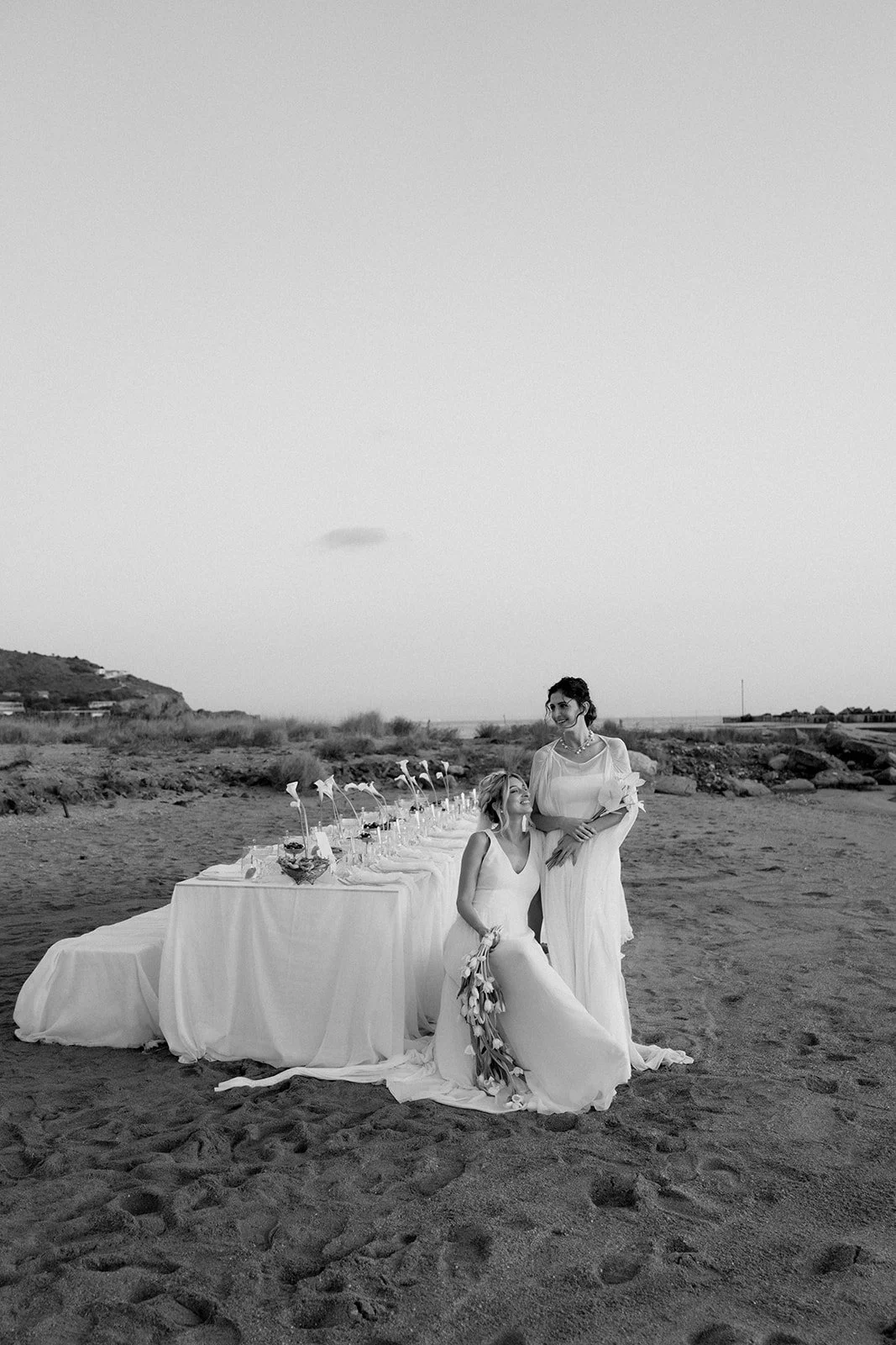 2 brides posing in a black and white picture 