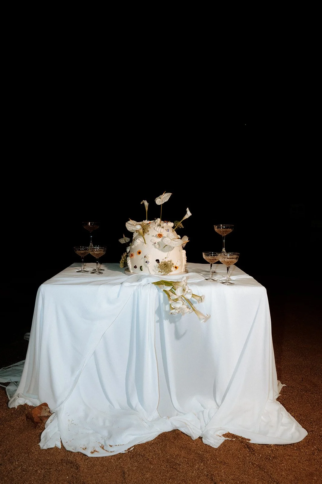 close up shot on wedding cake table with champagne 