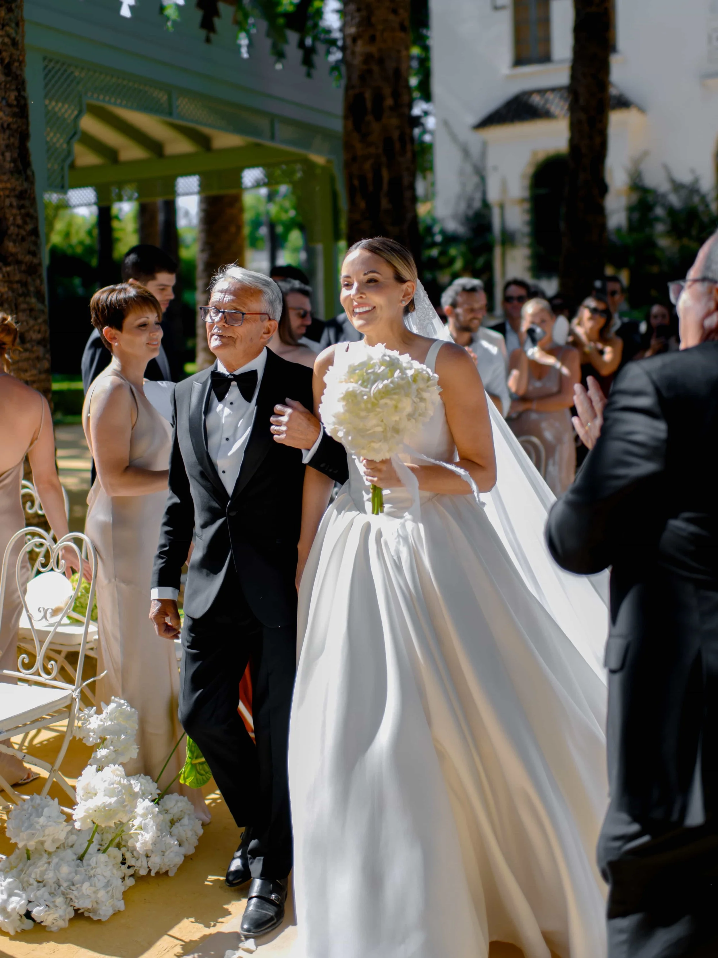 close up shot bride and her father while entering the ceremony 
